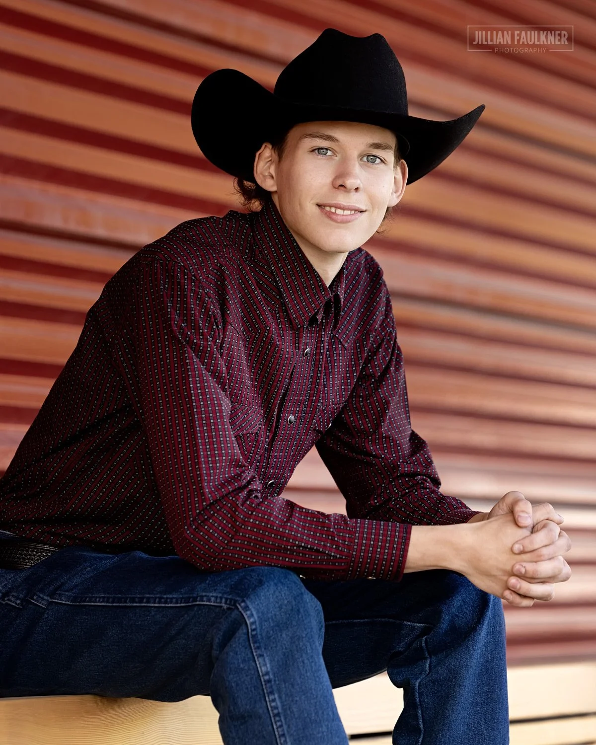 outdoor grad photo shoot at Sam Centre in Calgary, Alberta highlighting male high school graduate who loves western wear
