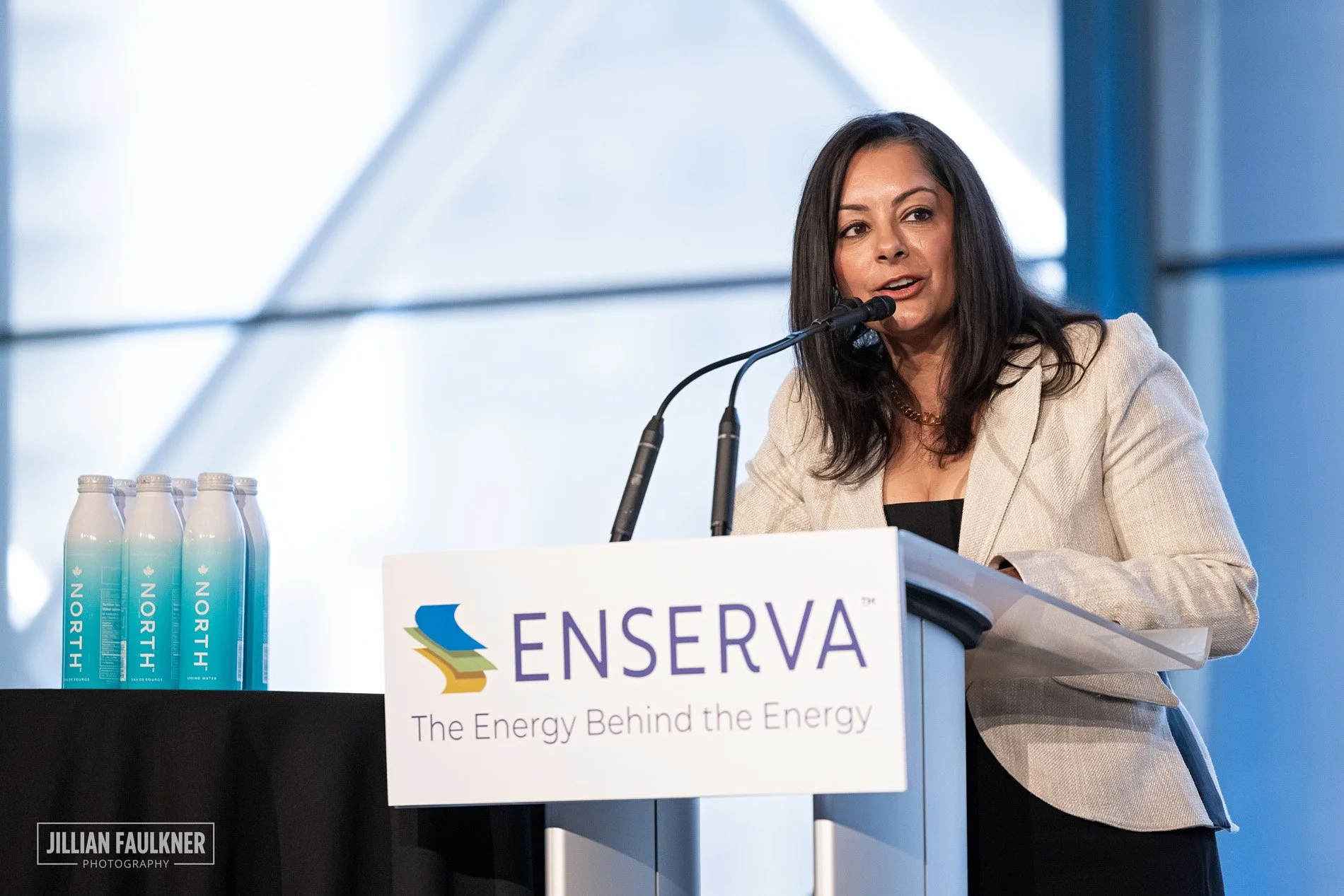 Event photography of corporate executive on stage at corporate luncheon at Telus Convention Centre