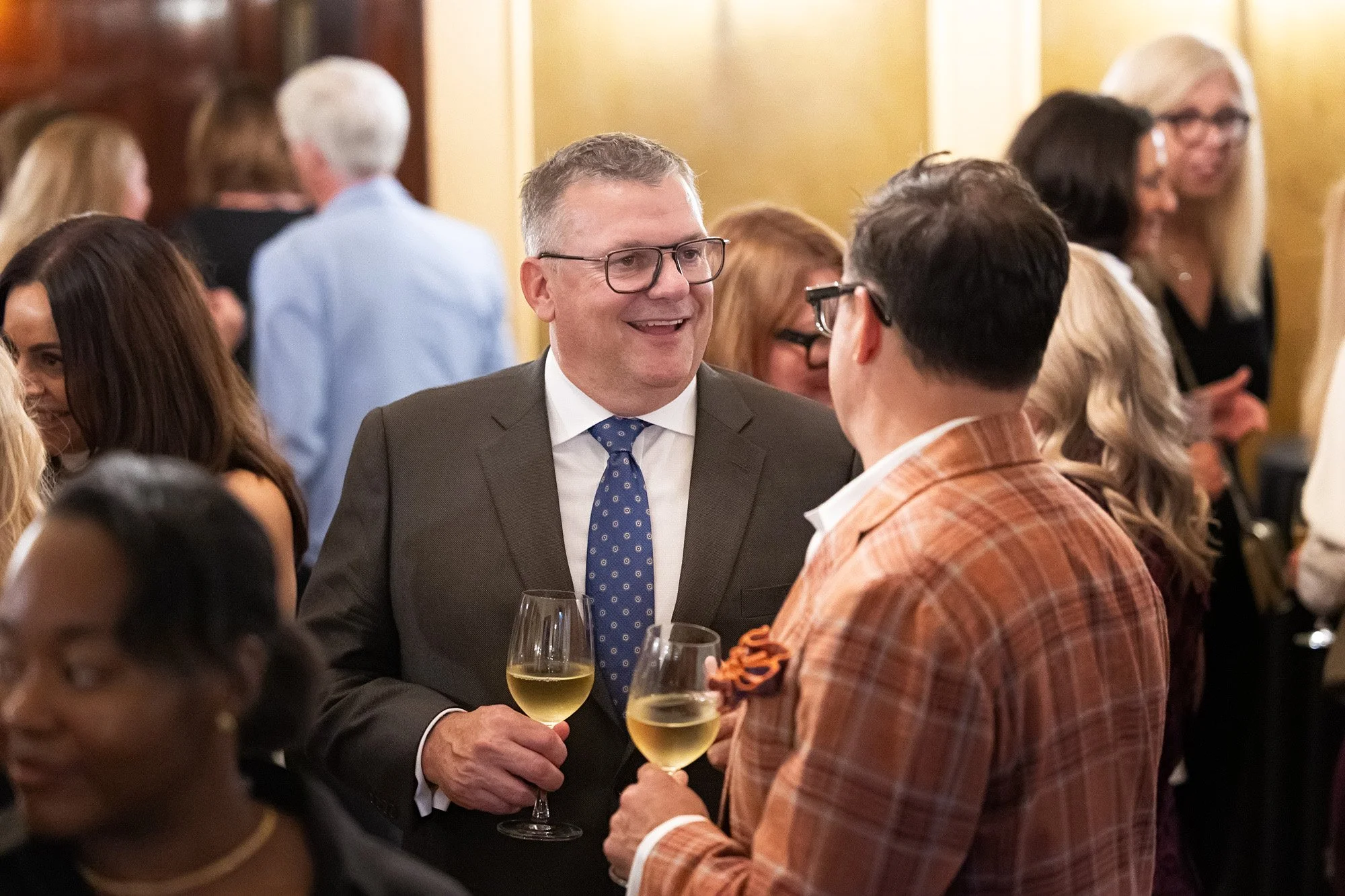 Calgary event photographer documents laugh between old friends reuniting at intimate Lougheed House anniversary event