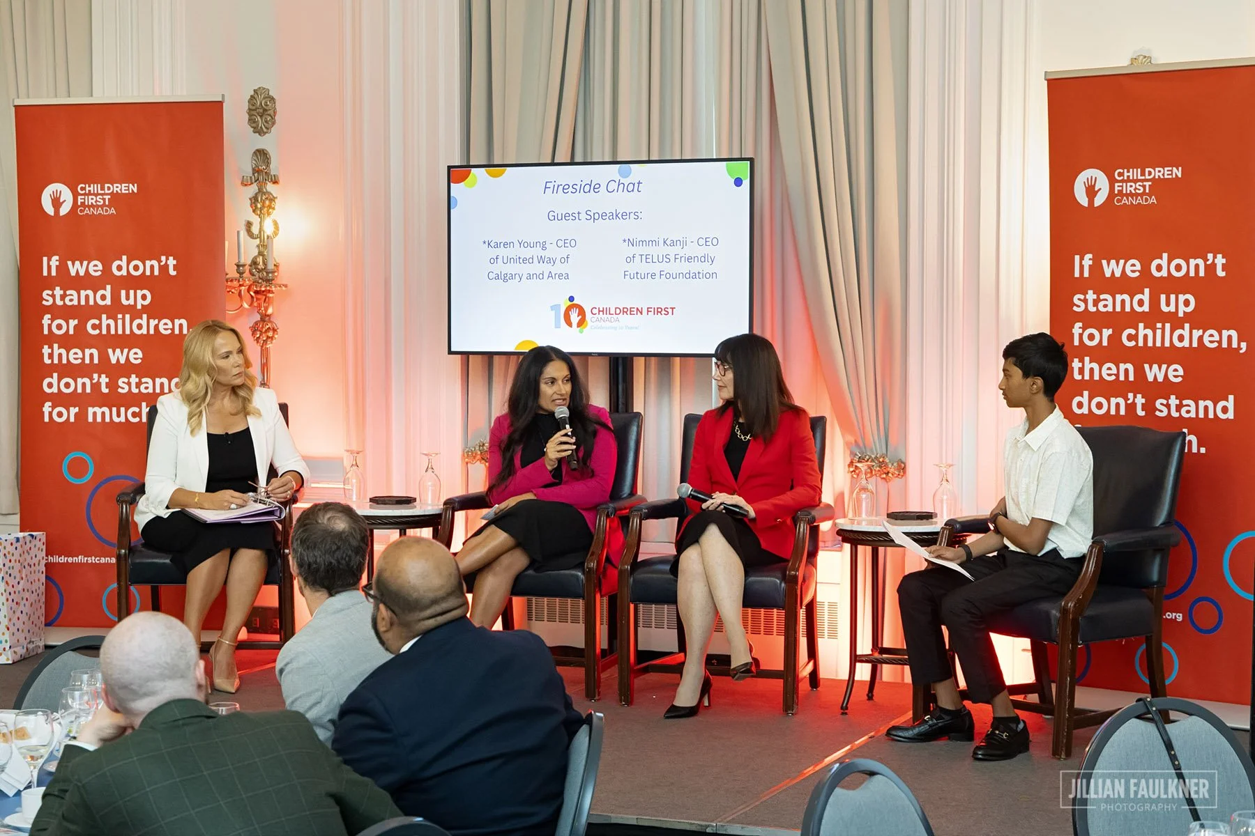 Panel of speakers seated on stage at Children First Canada gala event in Calgary