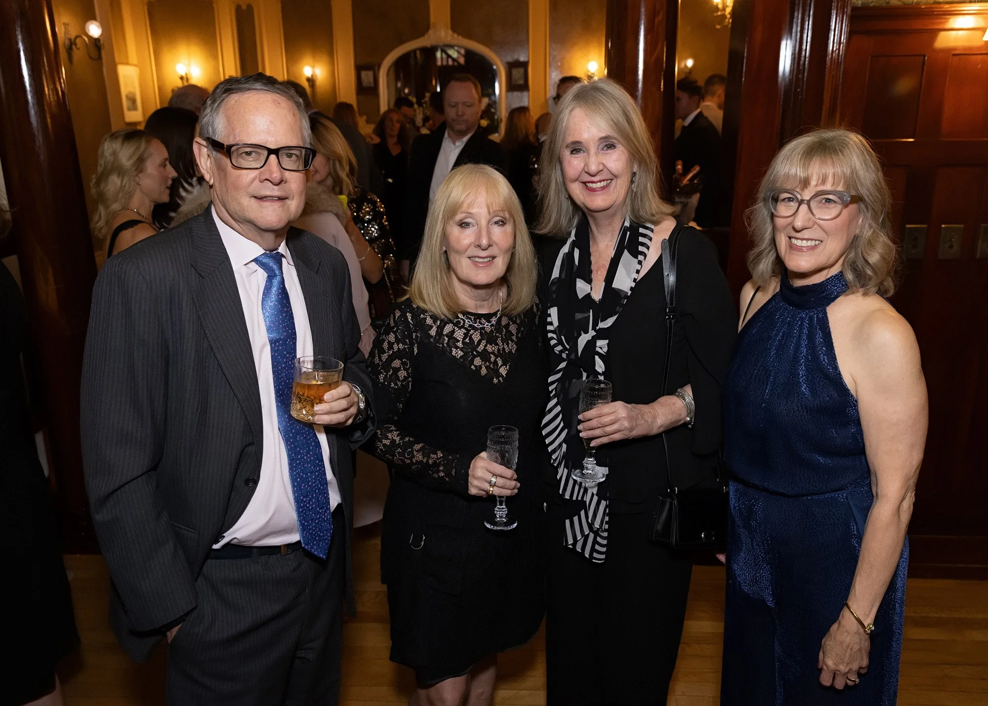 Professionally posed group portrait of guests at Lougheed House 20th anniversary private event Calgary