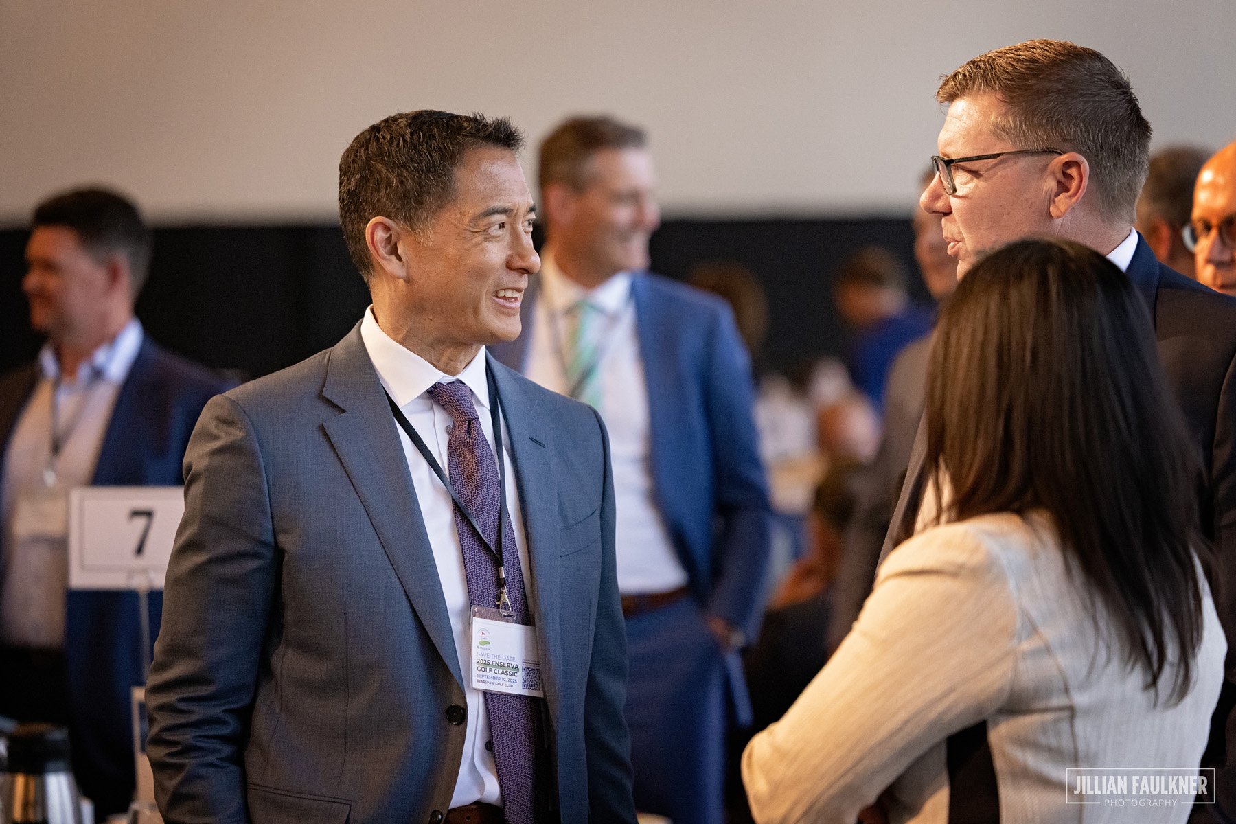Candid event photography Calgary energy industry professionals networking at Enserva Drive to Double summit