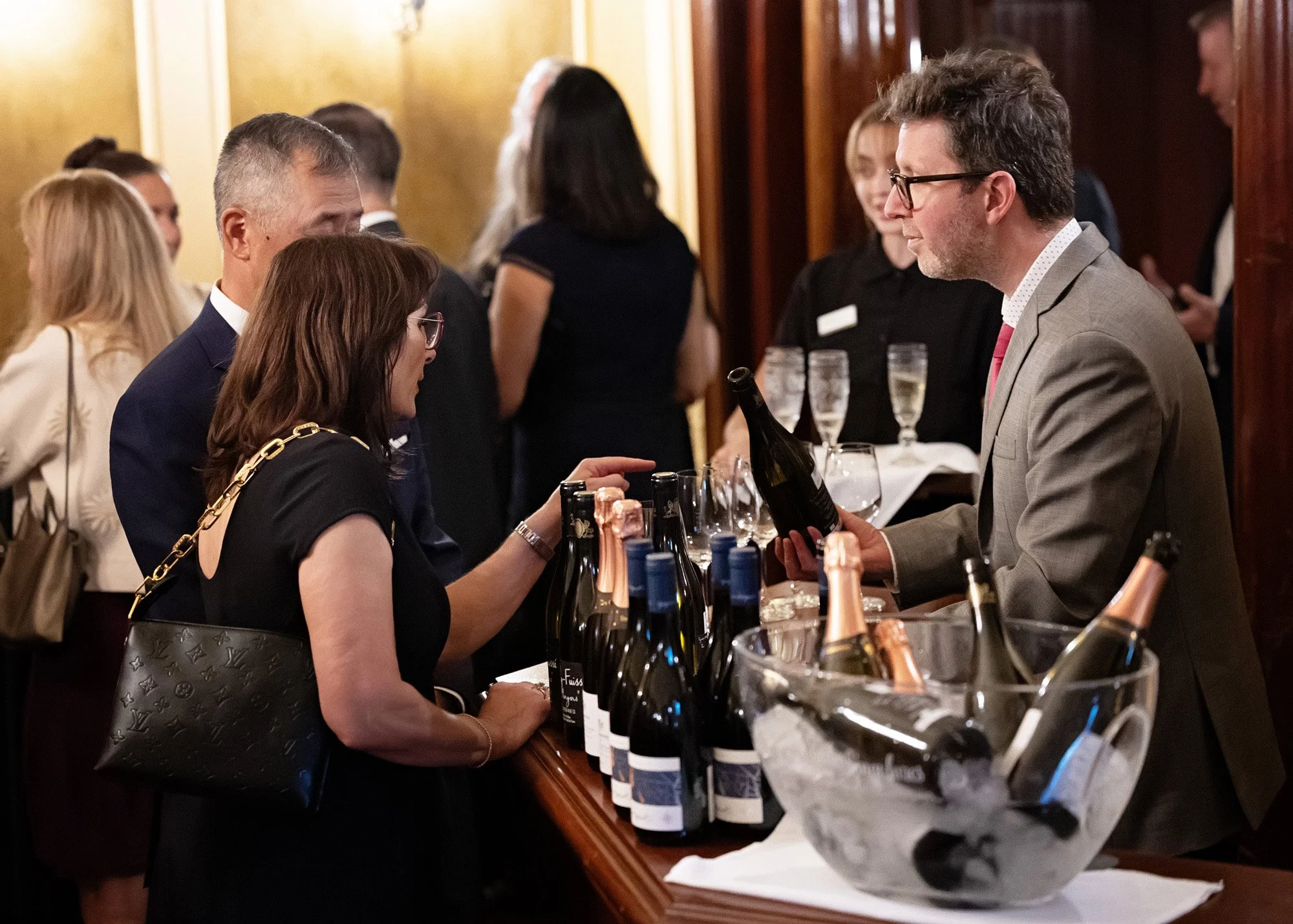 Candid event photography of guests mingling at Lougheed House 20th anniversary celebration Calgary