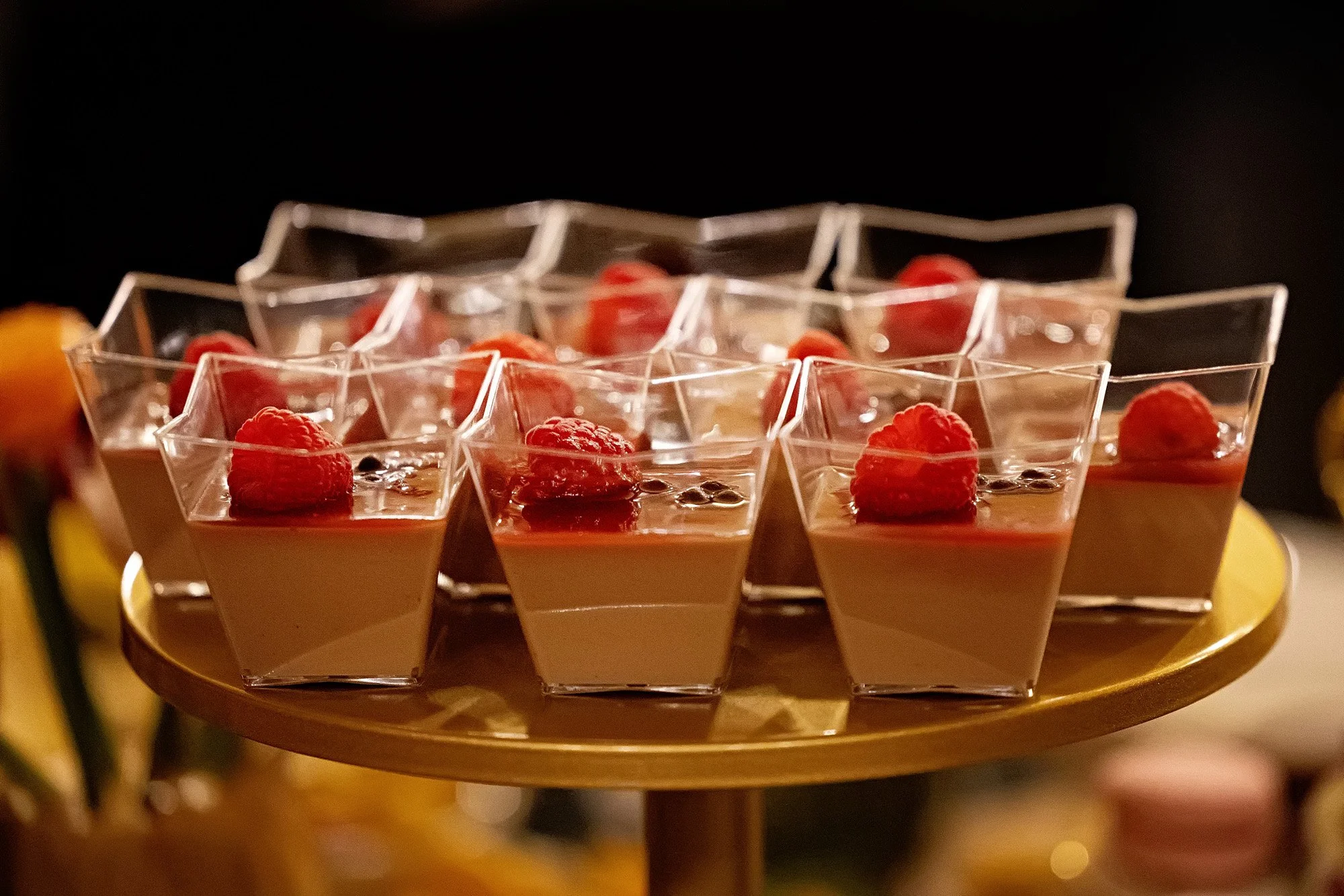 Close-up professional event photography of individually plated desserts and sweets table