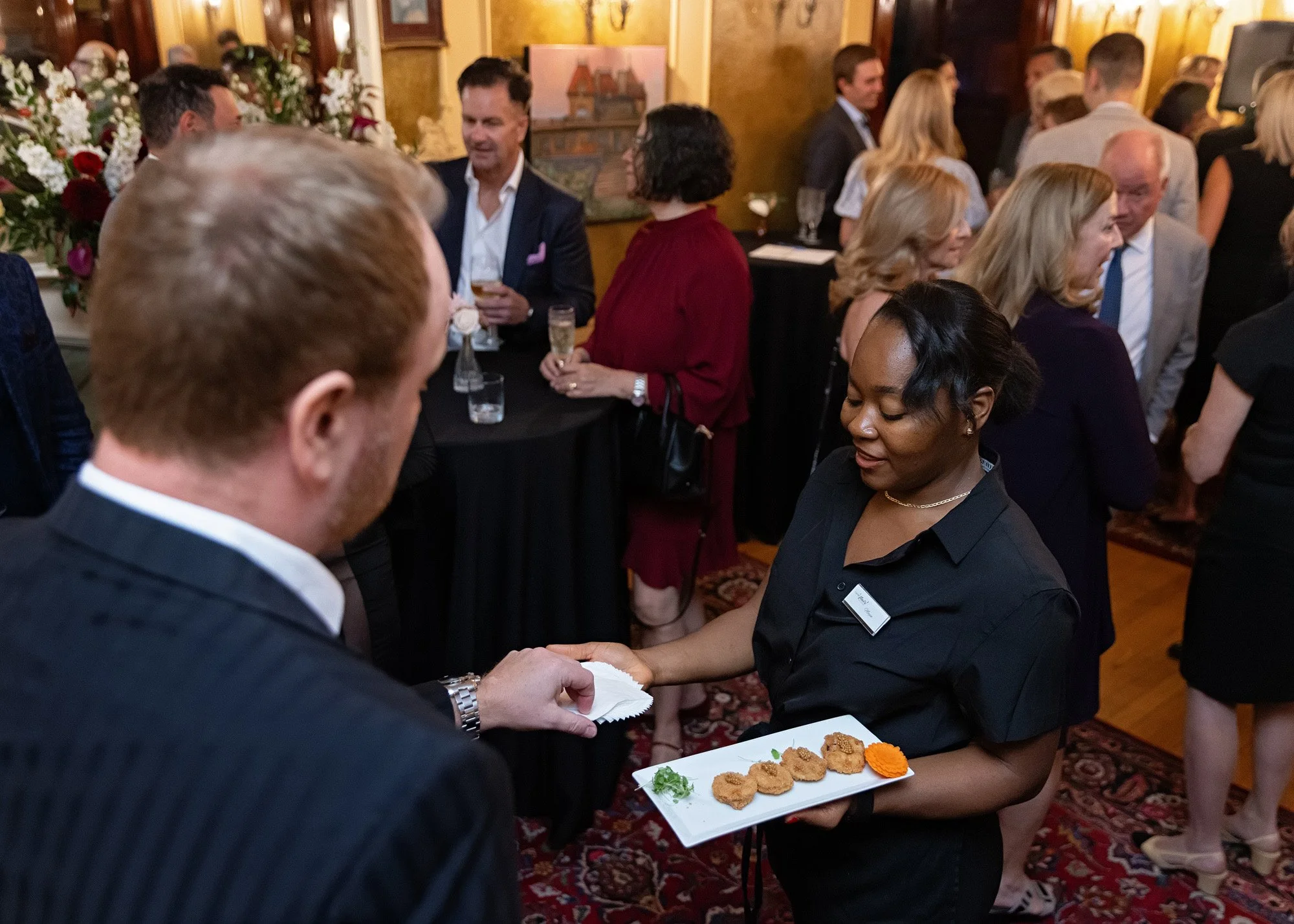 Professional event photographer captures elegant tapas service at intimate Lougheed House Calgary gala