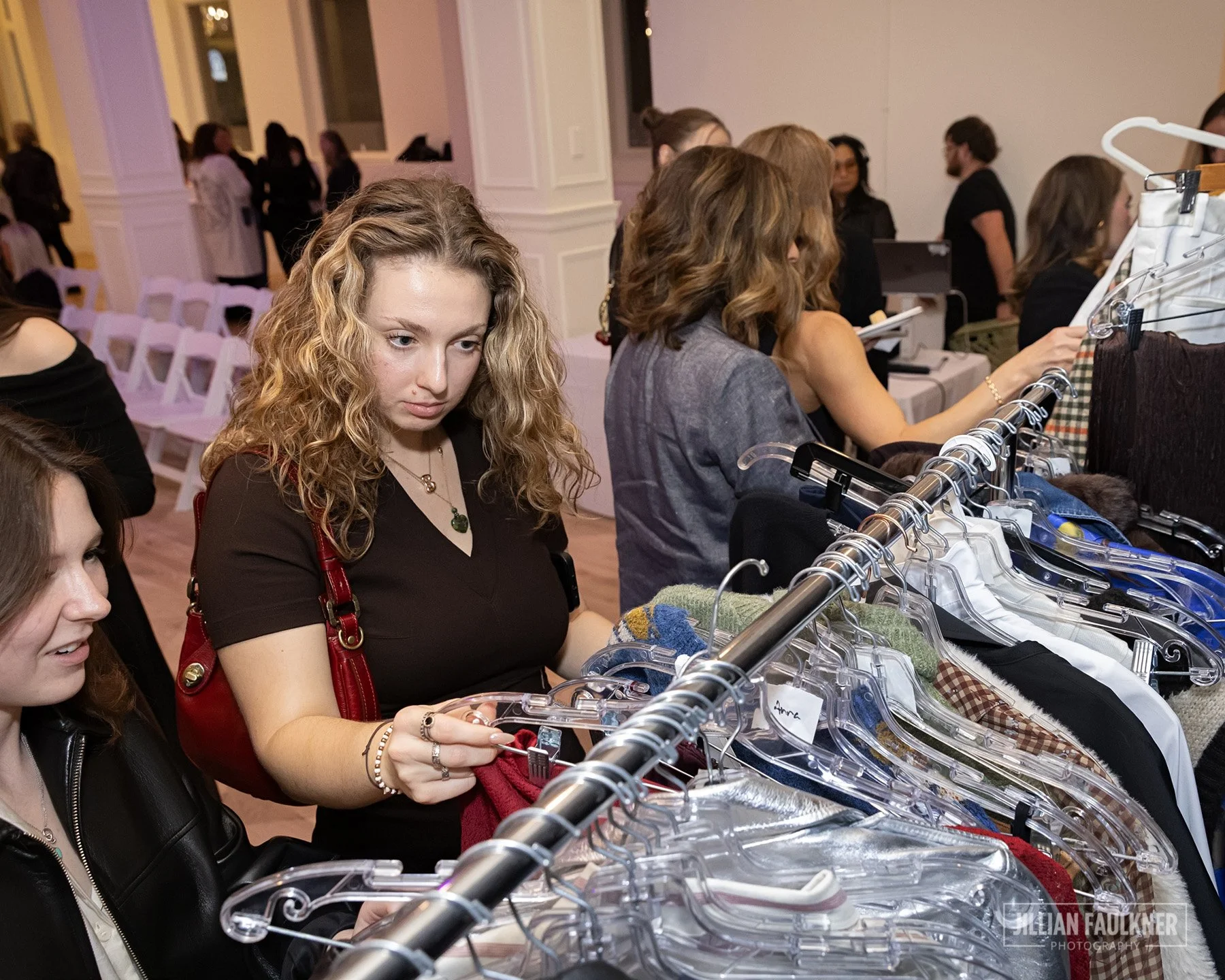 Calgary event photographer captures guests browsing Crystal McKenzie's exclusive curated fall and winter designer collections available for purchase at Brookline PR's 20th Anniversary Fall Fashion Show