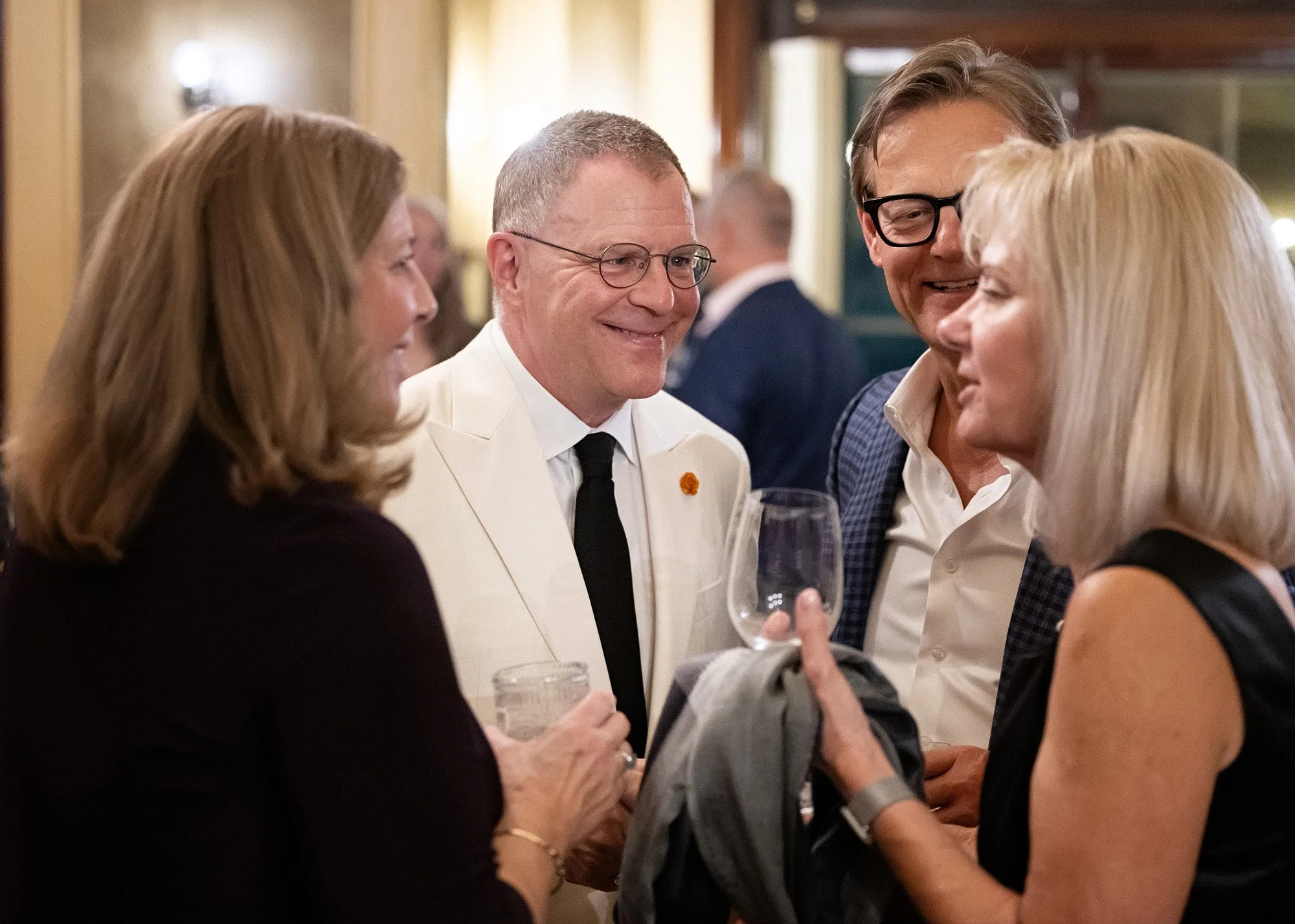 Professional event photographer captures unposed emotional moment between guests at Calgary anniversary celebration