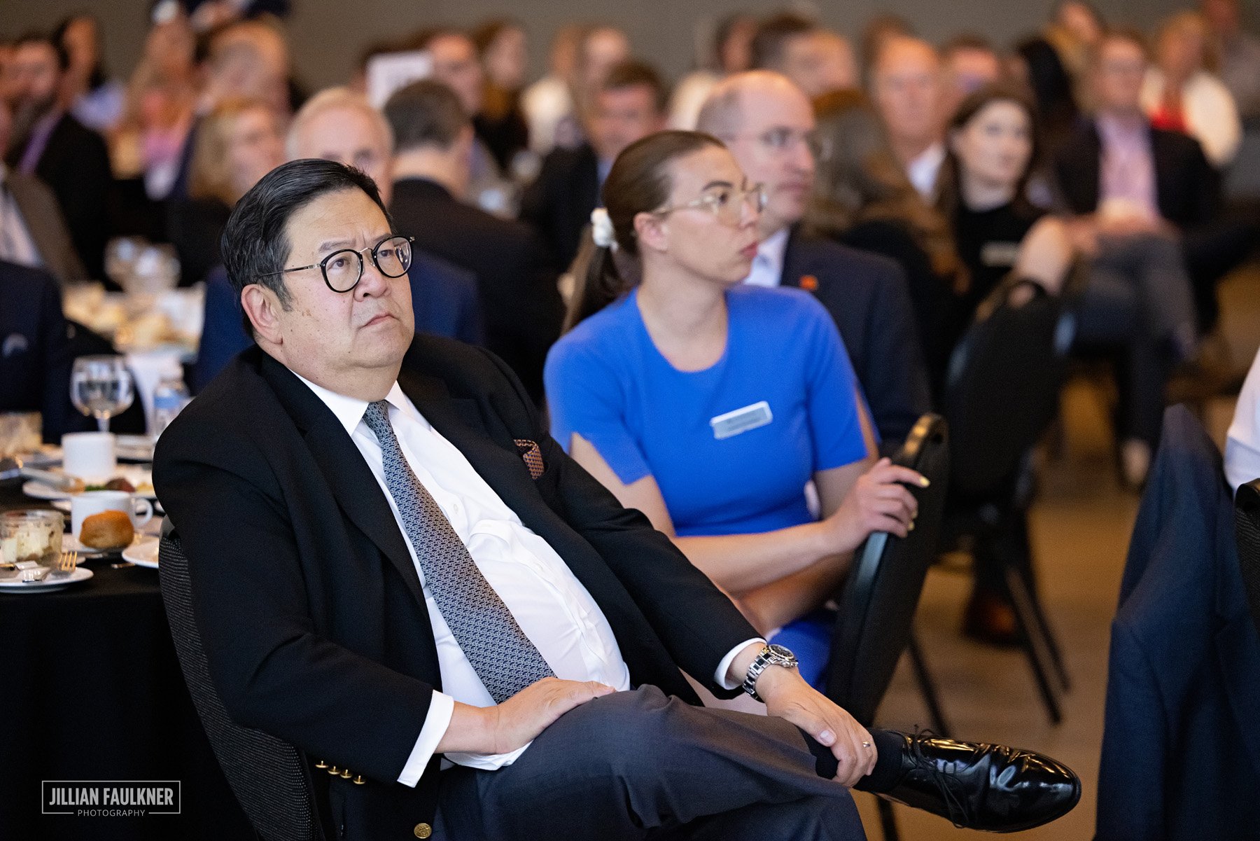 Professional Calgary event photographer captures candid moments between industry leaders at corporate summit