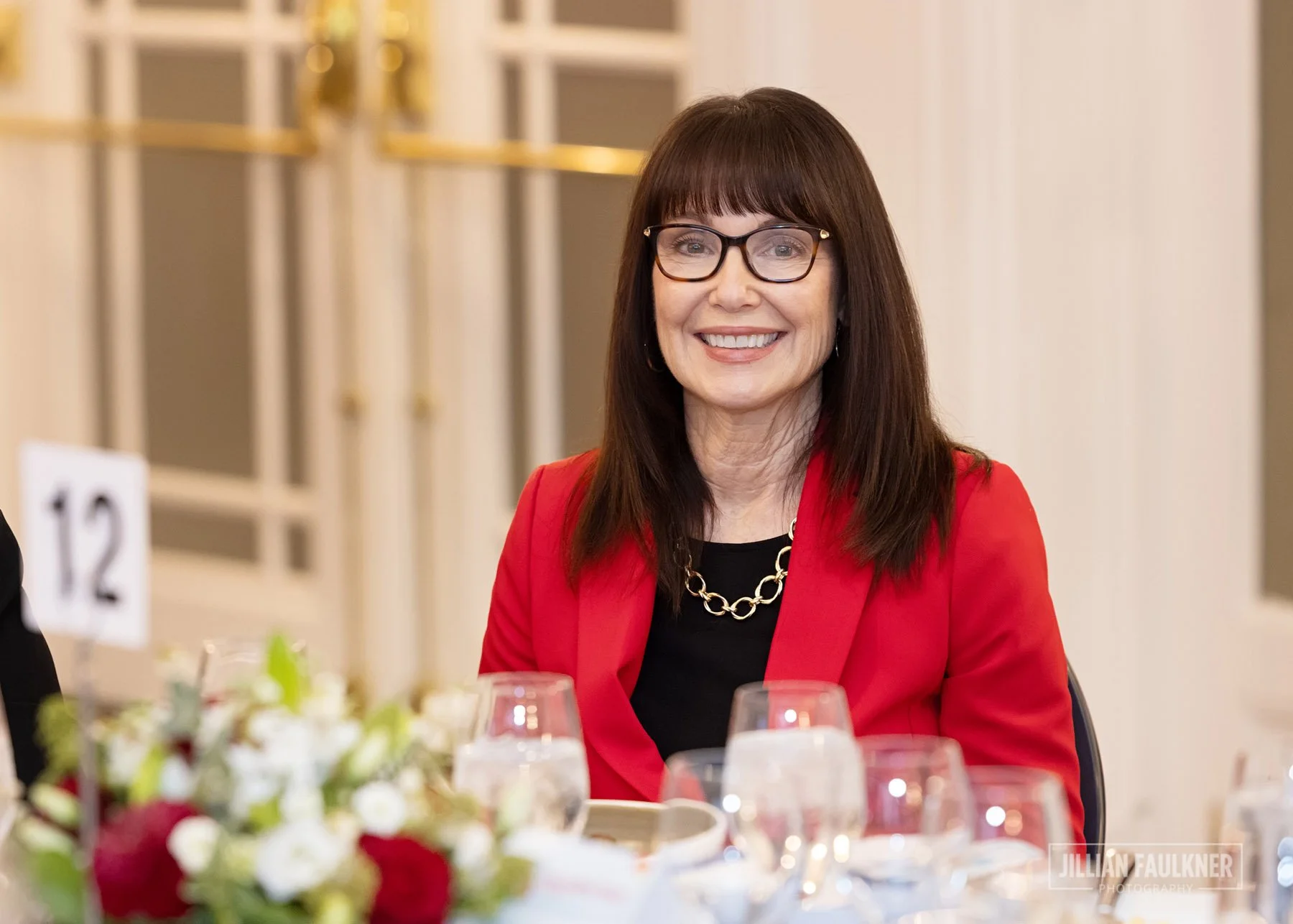 Calgary event photographer documenting female smiling at gala luncheon