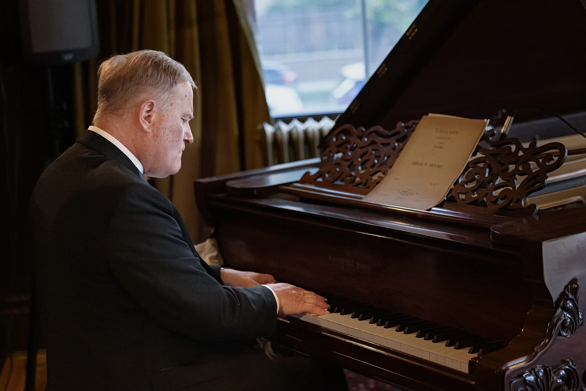 Professional event photography of piano player at Lougheed House anniversary event