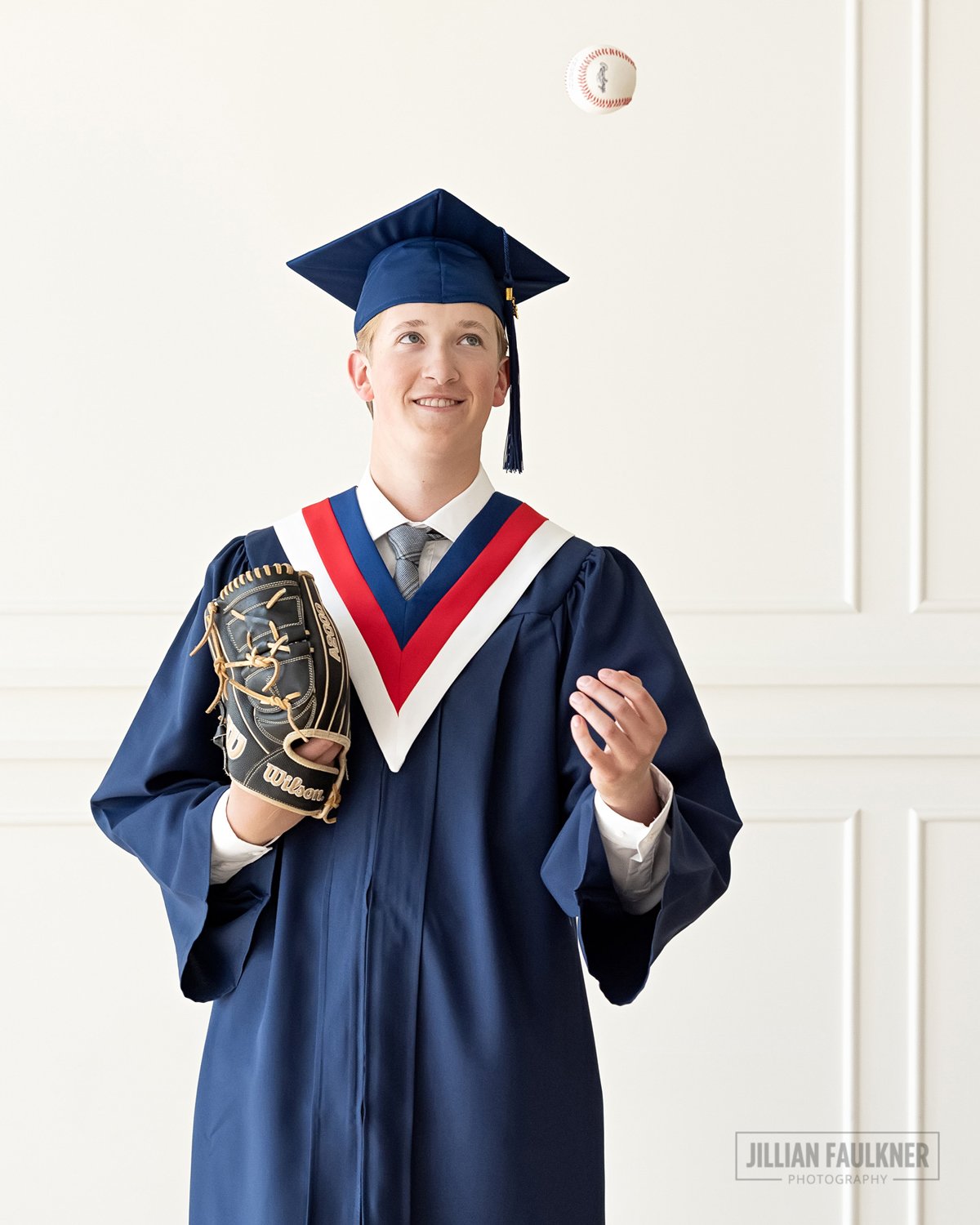 male high school graduation studio photography with baseball, baseball mitt, glove and cap and gown