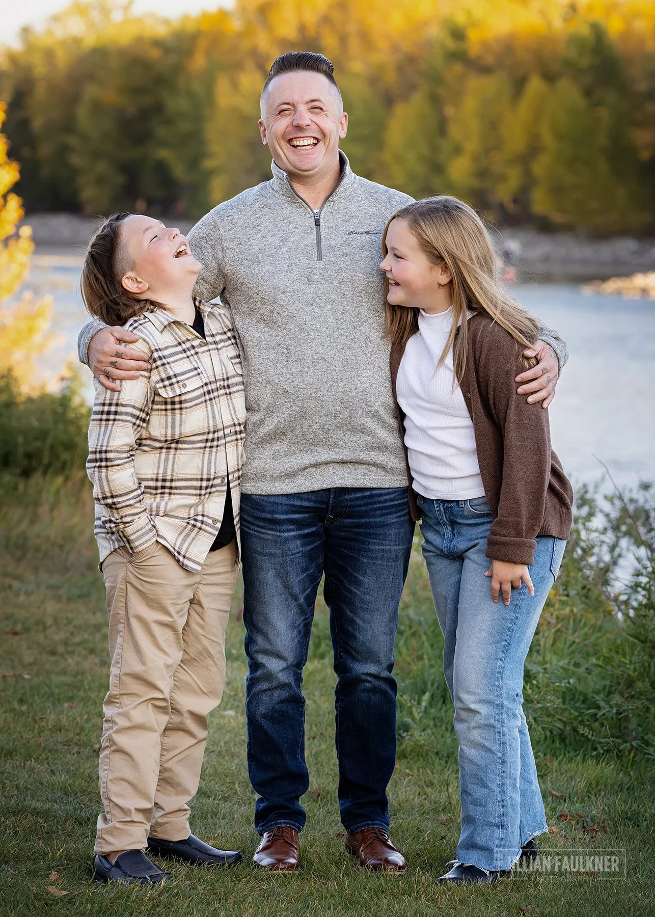 family pictures on grassy hill overlooking the Bow River