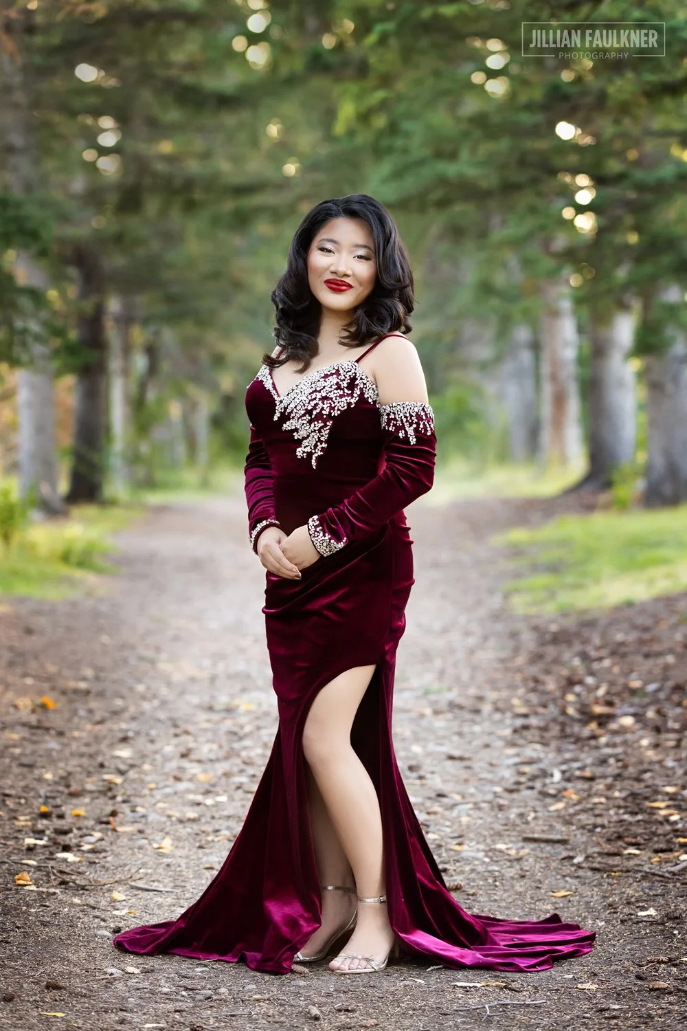 graduation photo shoot at Baker Park in Calgary, Alberta with female graduate in full length grad gown