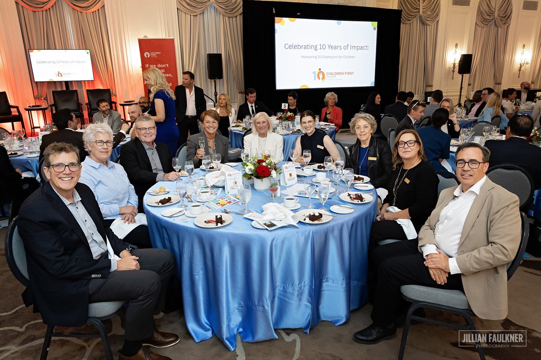 Professional event photography Calgary - luncheon attendees posed at table