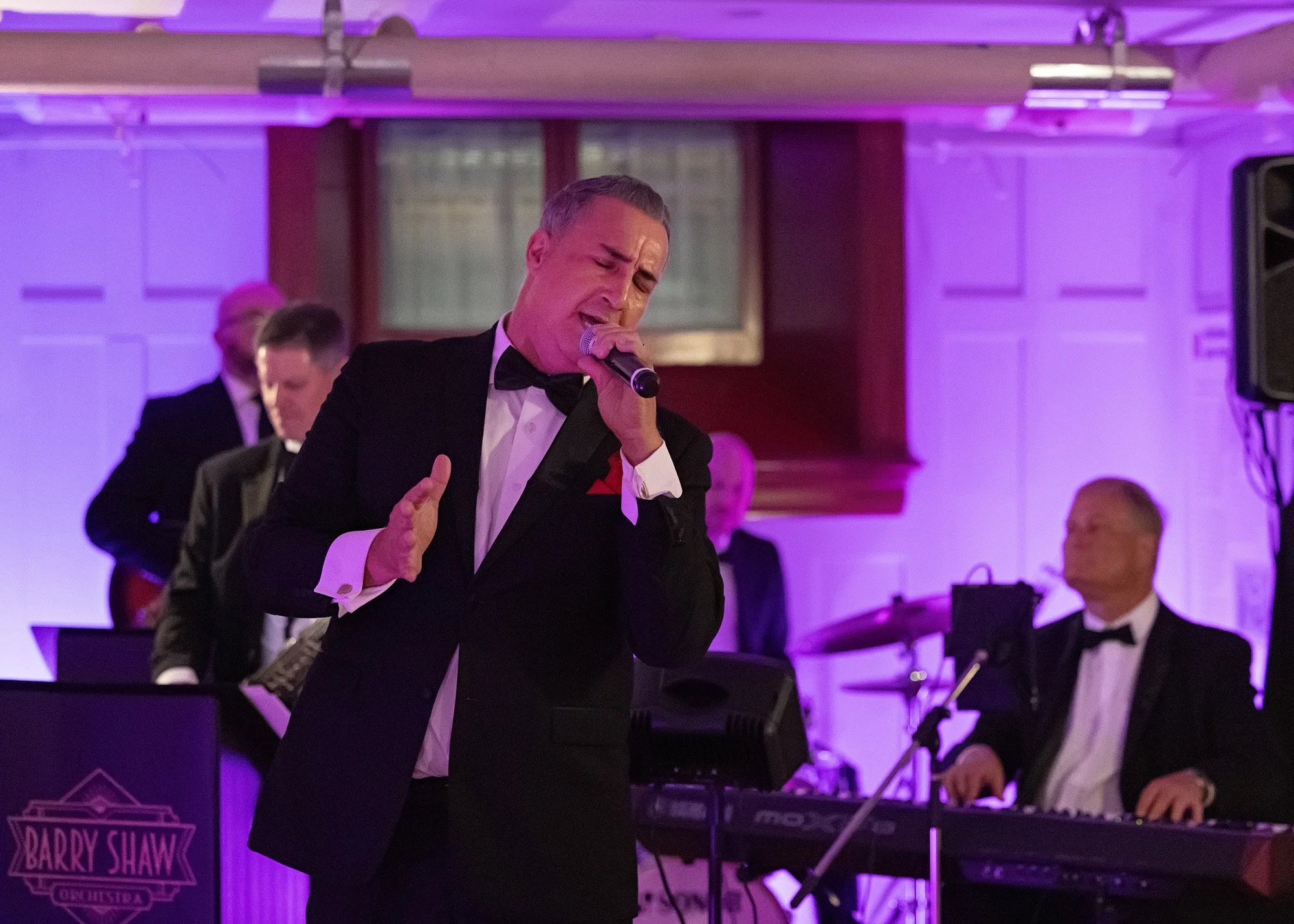 Professional event photography of live band musicians performing at historic Lougheed House