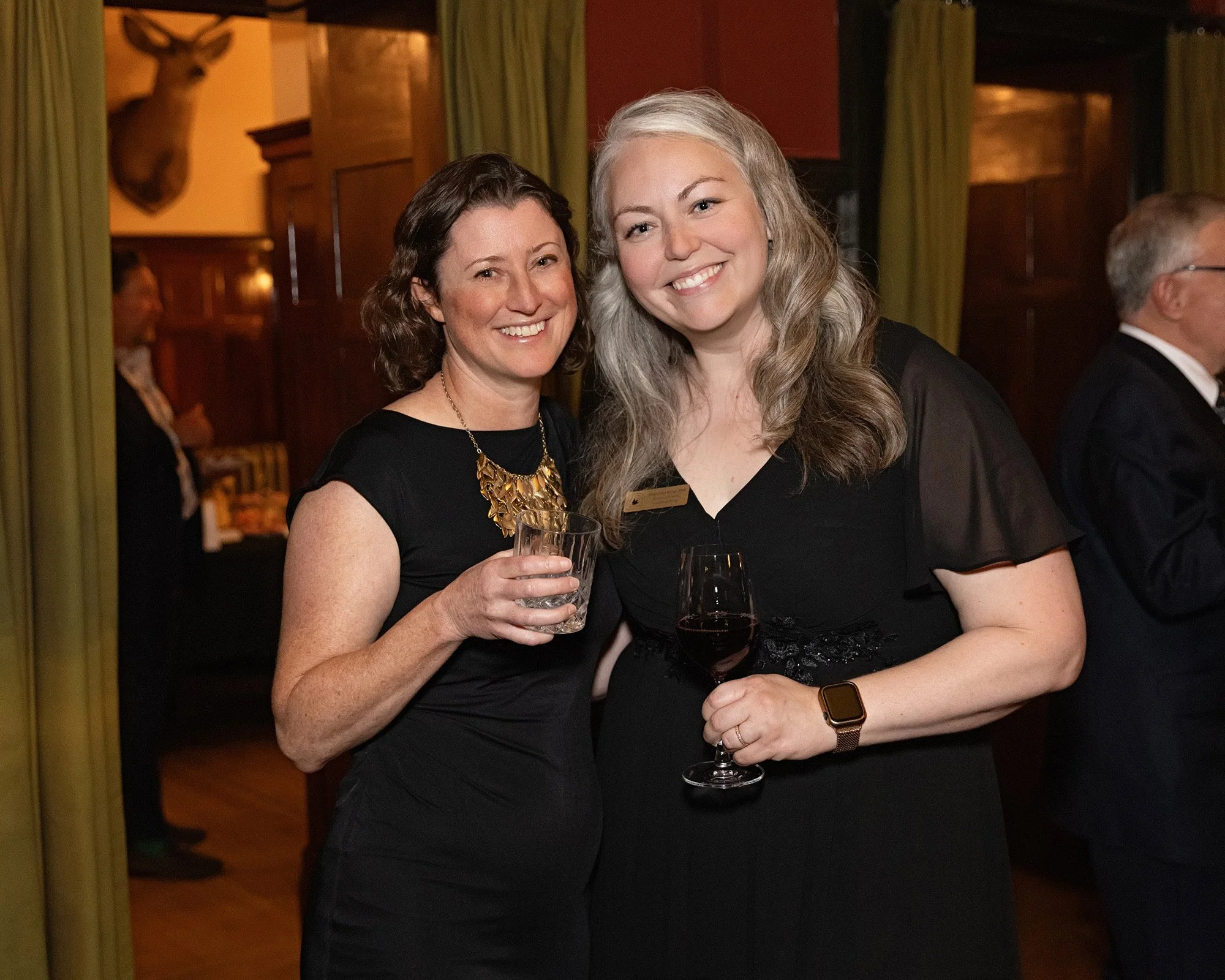 Professional candid photographer captures genuine laughter among guests at Calgary private event