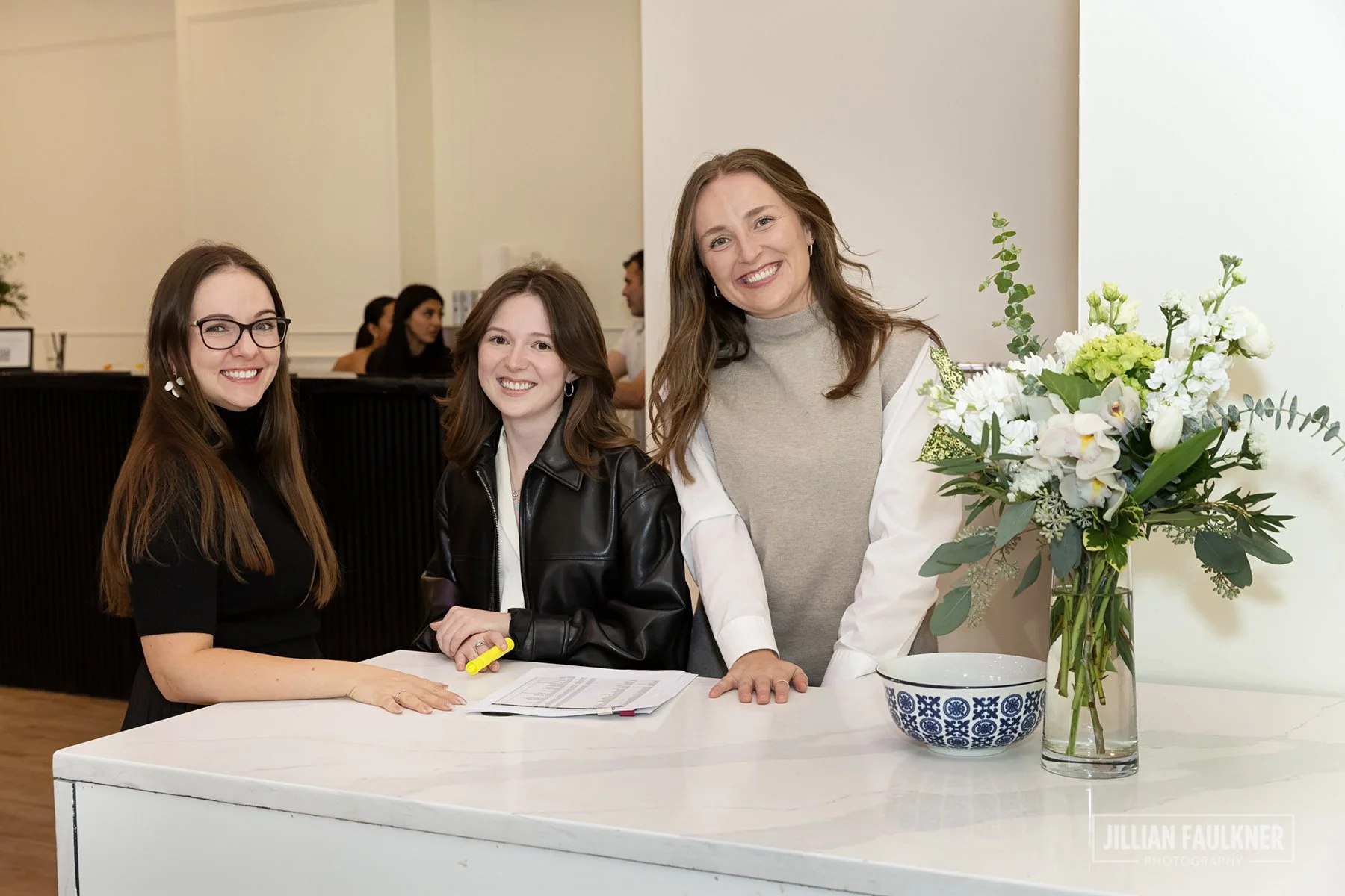 naturally posed portrait of 3 female hosts greeting guests