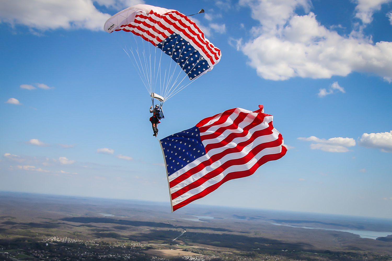 Skydiver flies the American Flag