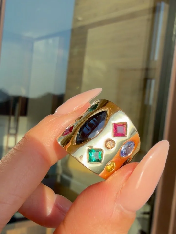 🥳HAPPY 2026!!!🎉✨ This insane 18K vintage confetti band is available! Featuring mixed cut sapphires, emeralds, citrines, topaz, garnet. Face measures 18.8mm long, size 5.5-6 and weighs 14.7 grams. Snag at $3700 Zelle/$3950 website as a reserved cust