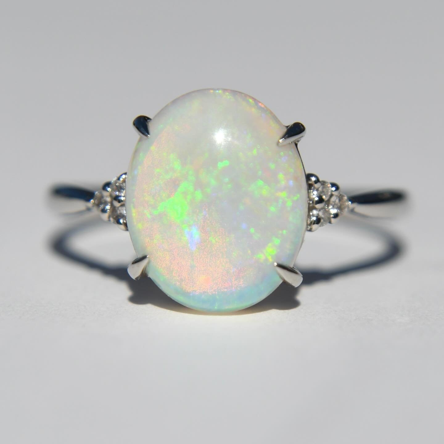 Who&rsquo;s snatching up this insanely beautiful vintage c1990s platinum Australian opal blue rainbow flash diamond accent ring?! In pristine condition 🌈🔥💎 Online now, link in bio or tap to shop. 995 Zelle or 1200 on the site #opal #australianopal