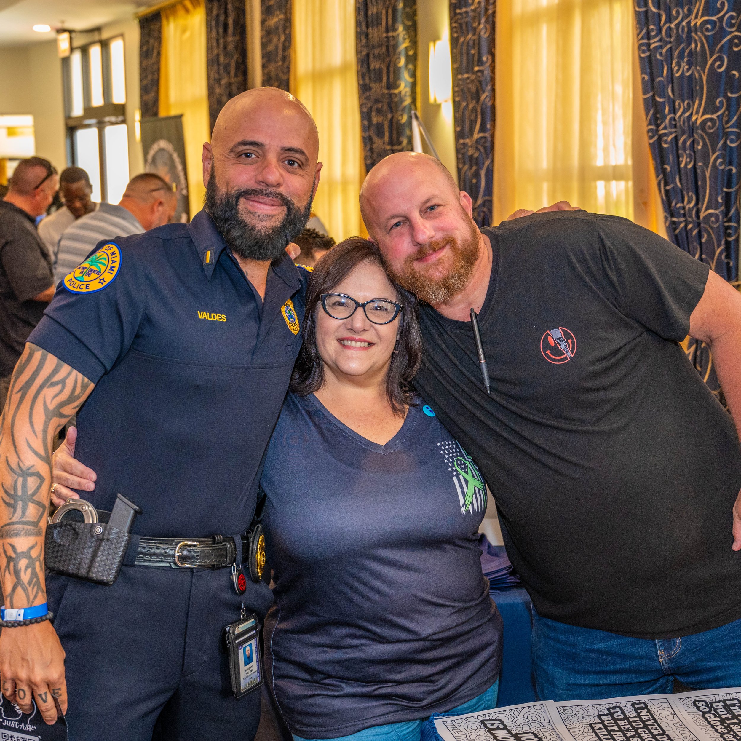 Two men and a woman smiling at camera
