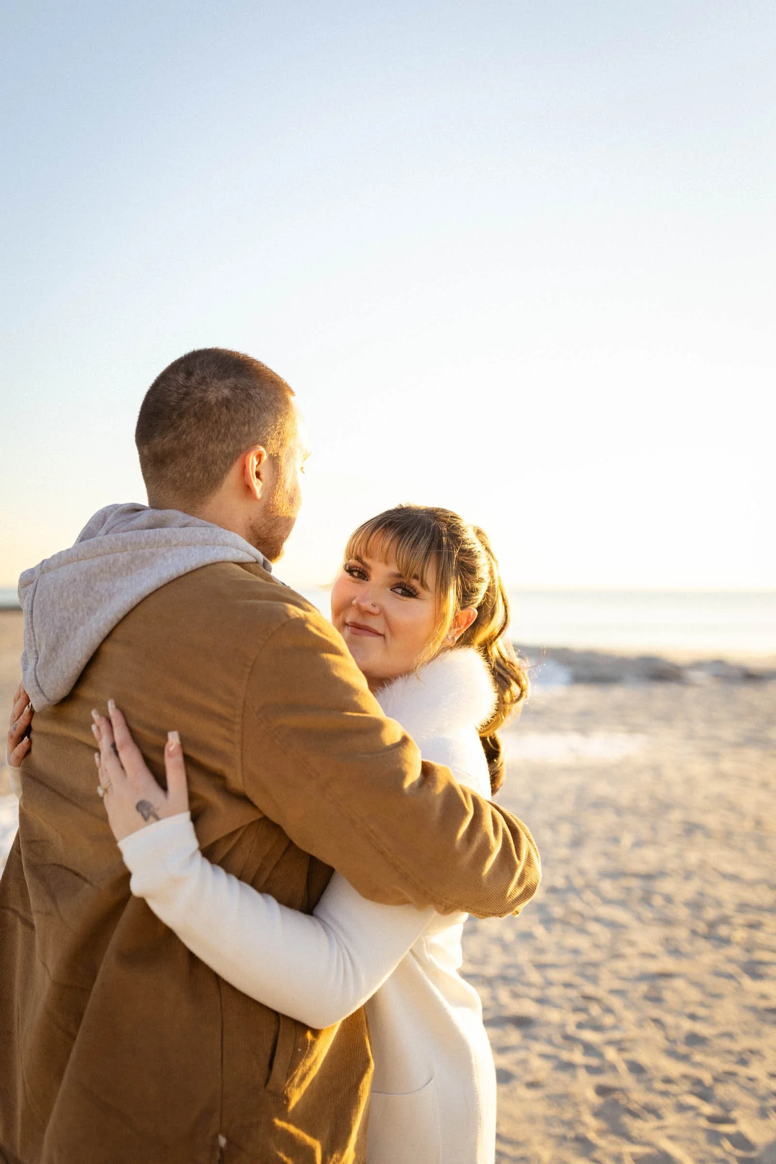  Couple embracing on beach at Long Beach, NY.  