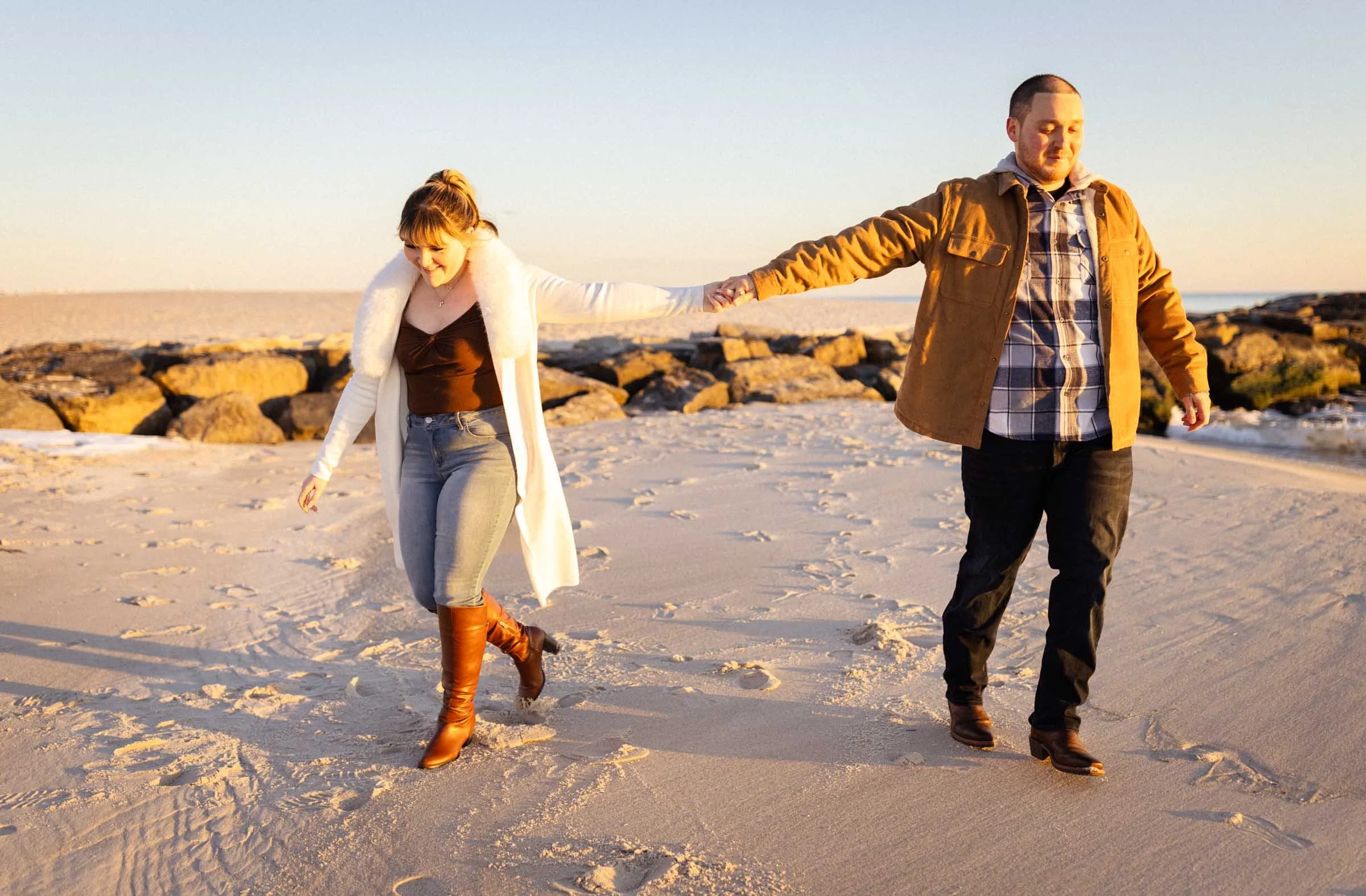  Couple holding hands on beach 