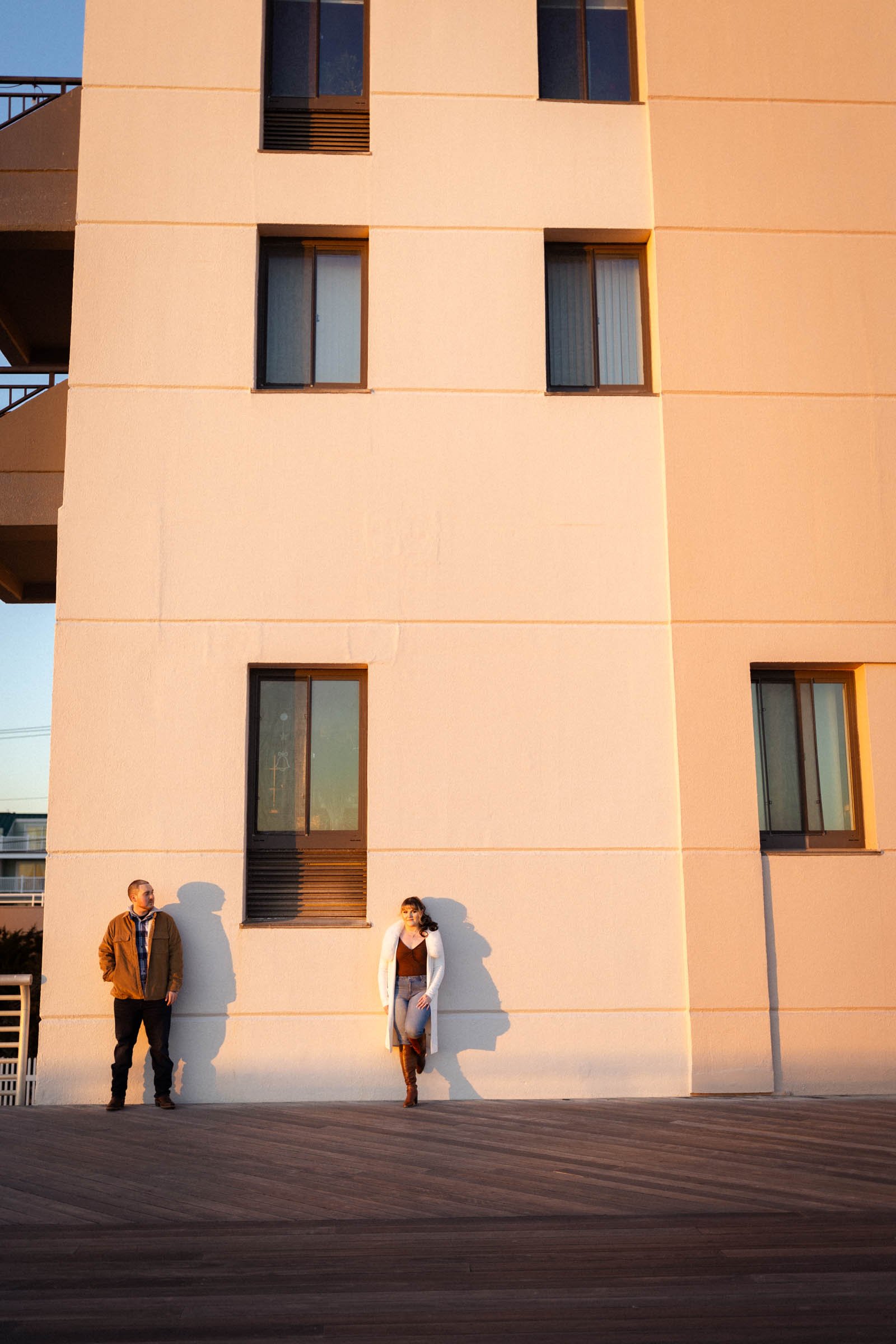  Couple standing against a tall building on boardwalk 