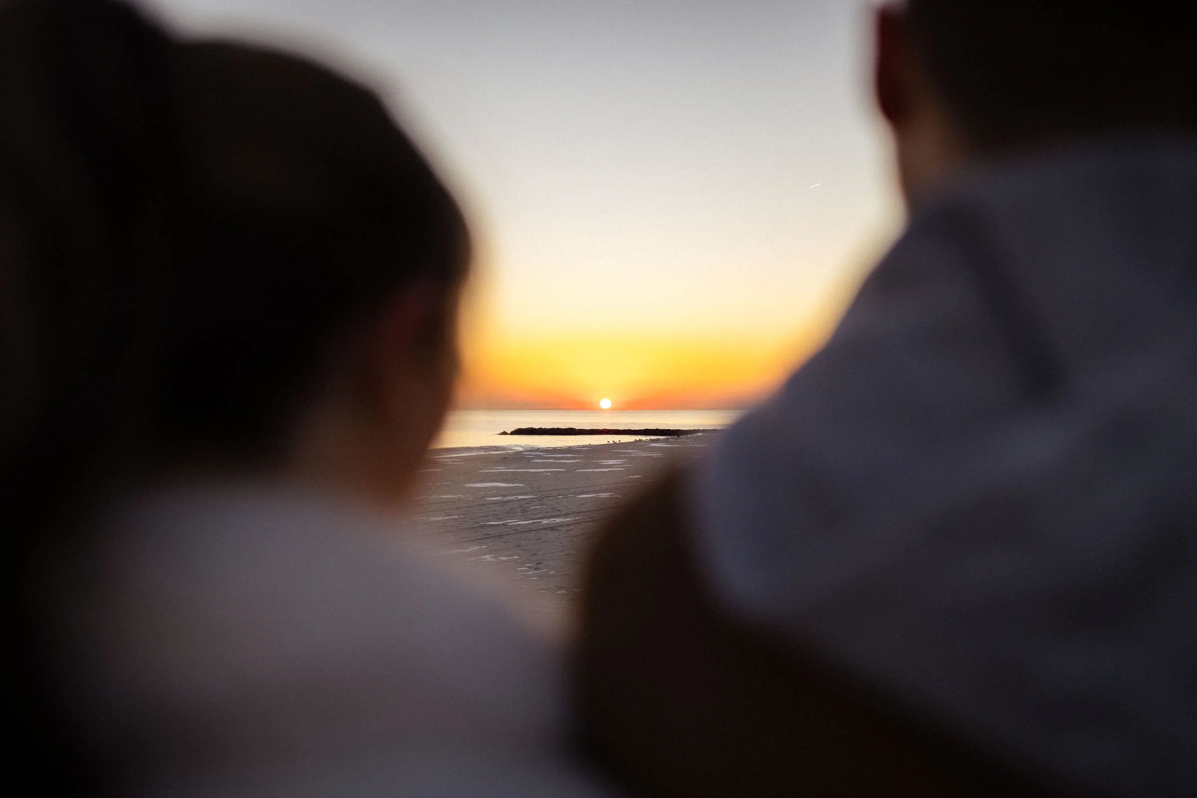  couple watching sunset on the beach 