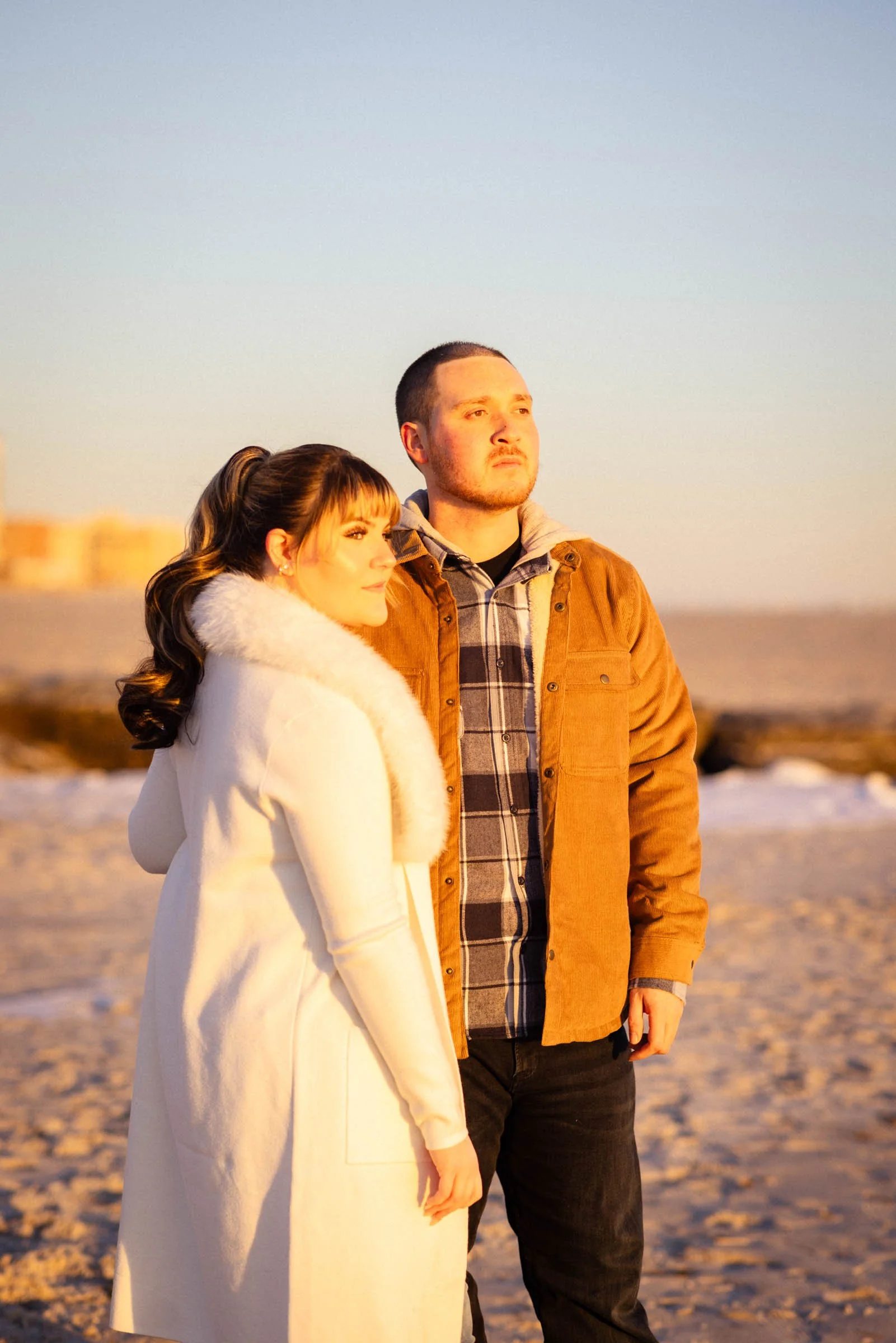  Couple on beach, staring at sun.  