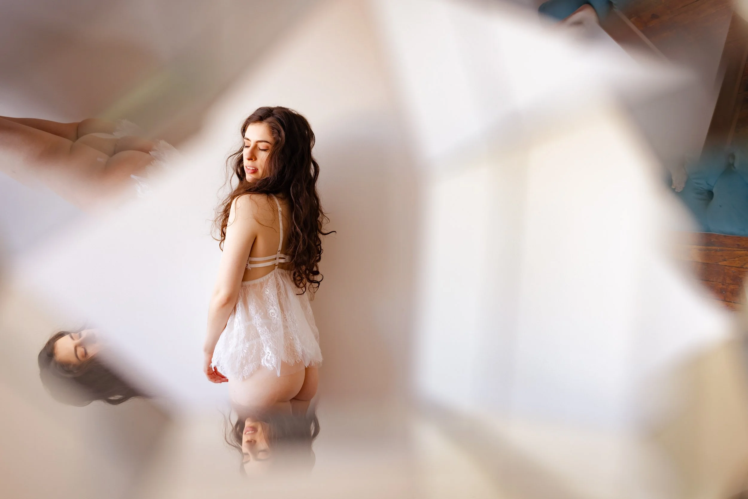 woman in lace with her back turned to the camera