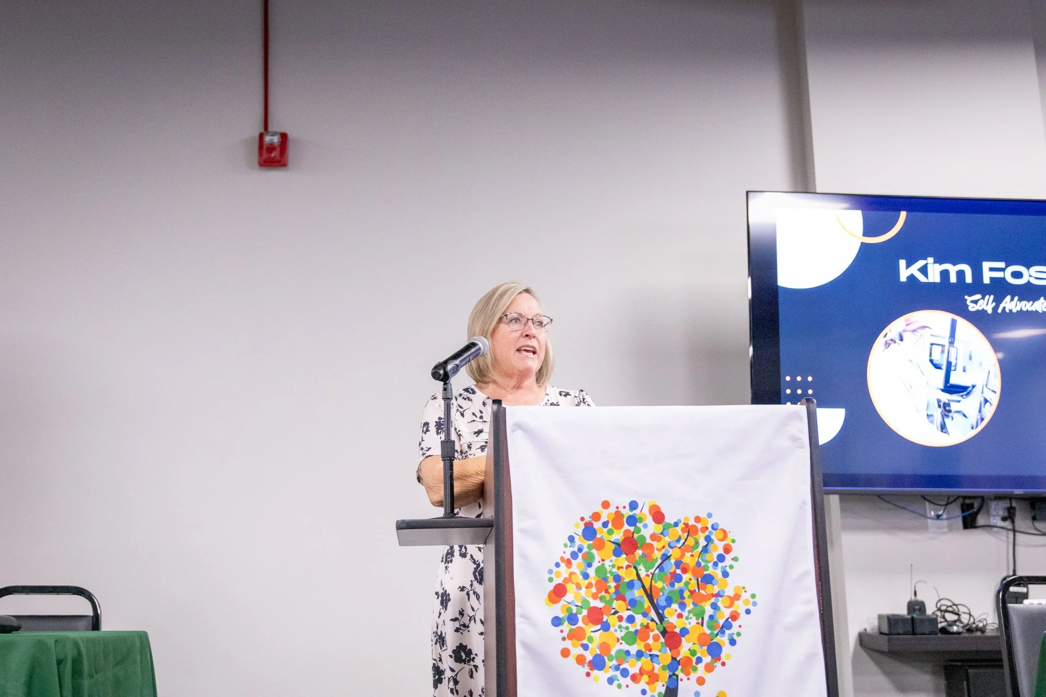 image of woman speaking at a podium