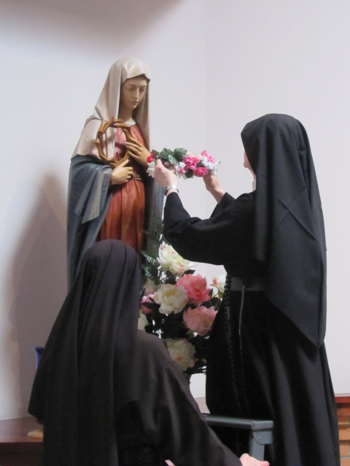  Sister Catherine Marie crowns our Blessed Mother in the back of the chapel 