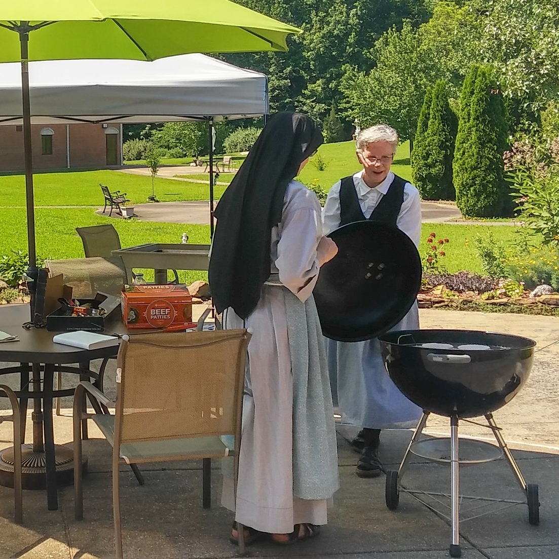  Christie giving Sr. Lucia Marie expert pointers on grilling hamburgers. 