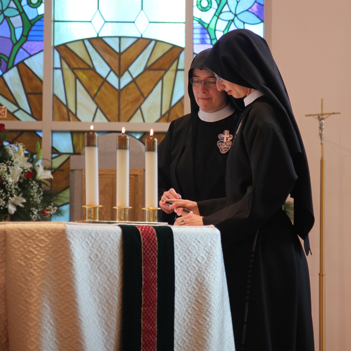  Sr. Cecilia Maria signs the profession formula which remains on the altar for the rest of the Mass, signifying her oblation of self in union with Jesus’ Eucharistic Sacrifice. 