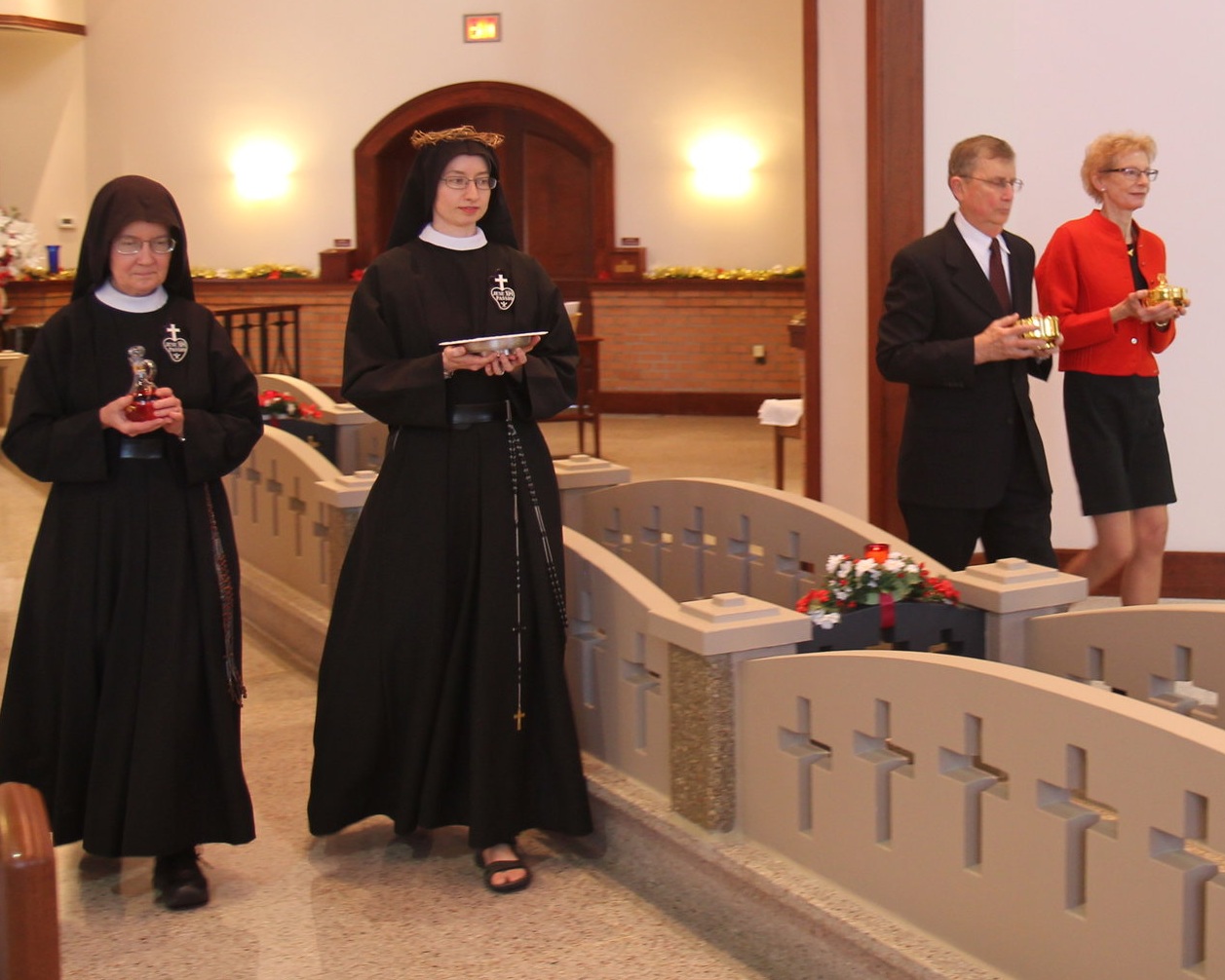  Sr. Mary Veronica, Sr. Cecilia Maria, and her parents, Tim &amp; Jane, bring the gifts to the altar in the offertory procession 
