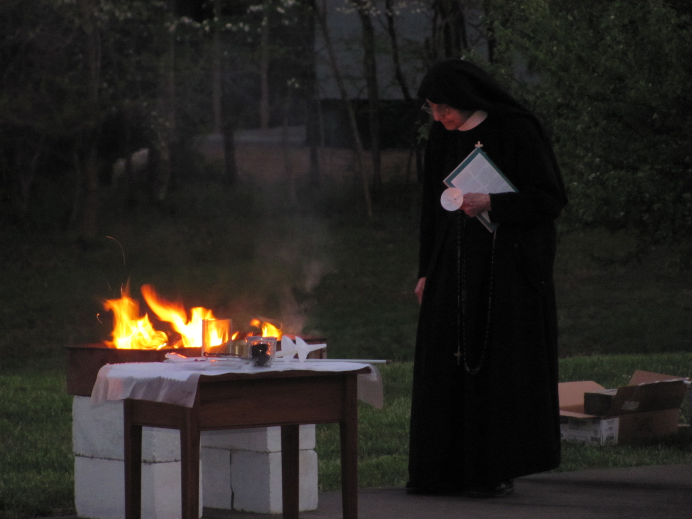  Sr. Marie Michael, our sacristan, tends the Paschal fire just before the Easter Vigil begins 