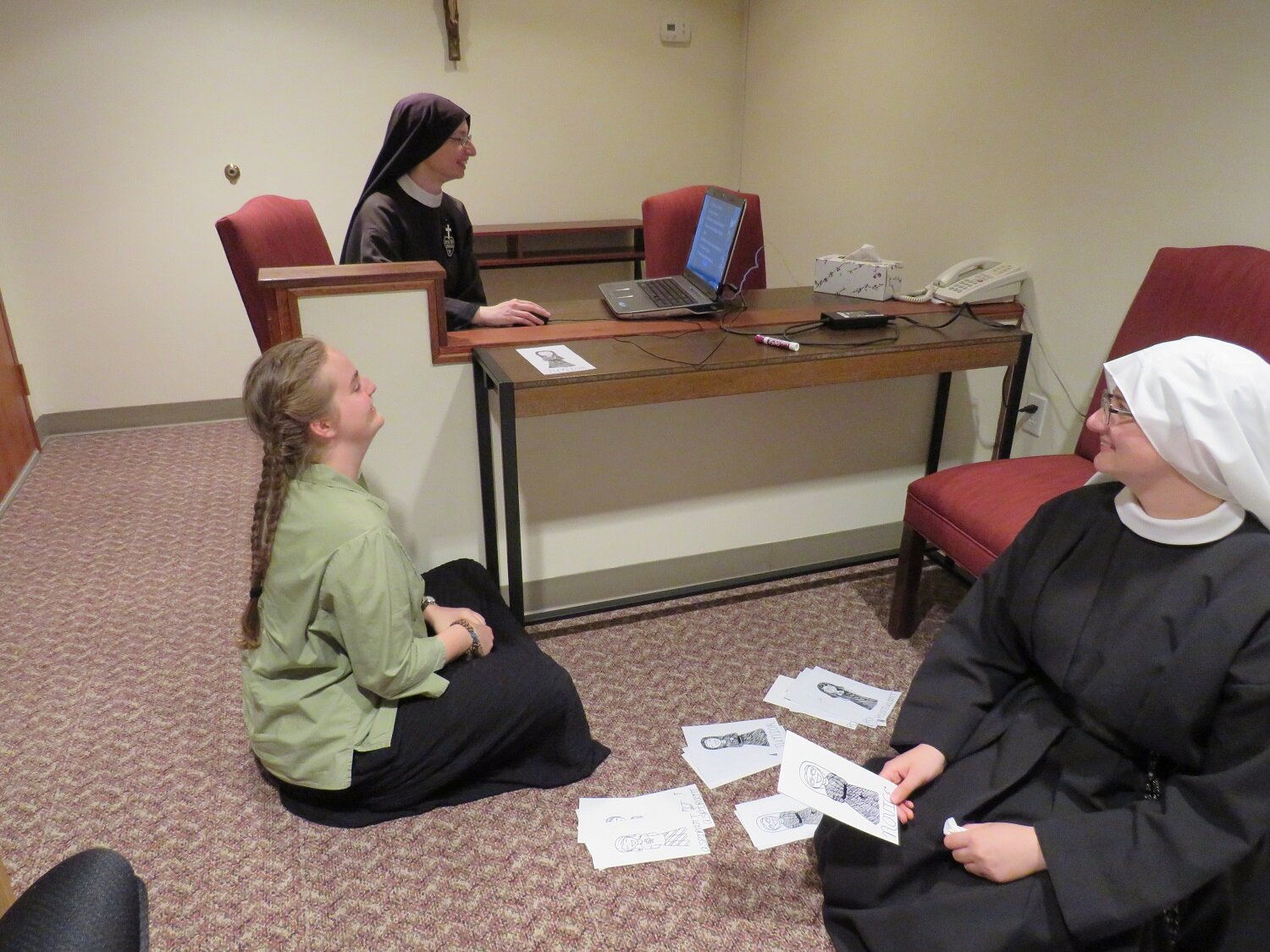  Sister Cecilia Maria, Aspirant Abbey, and Sister Miriam Esther set up for the “Monastery Jeopardy” game 