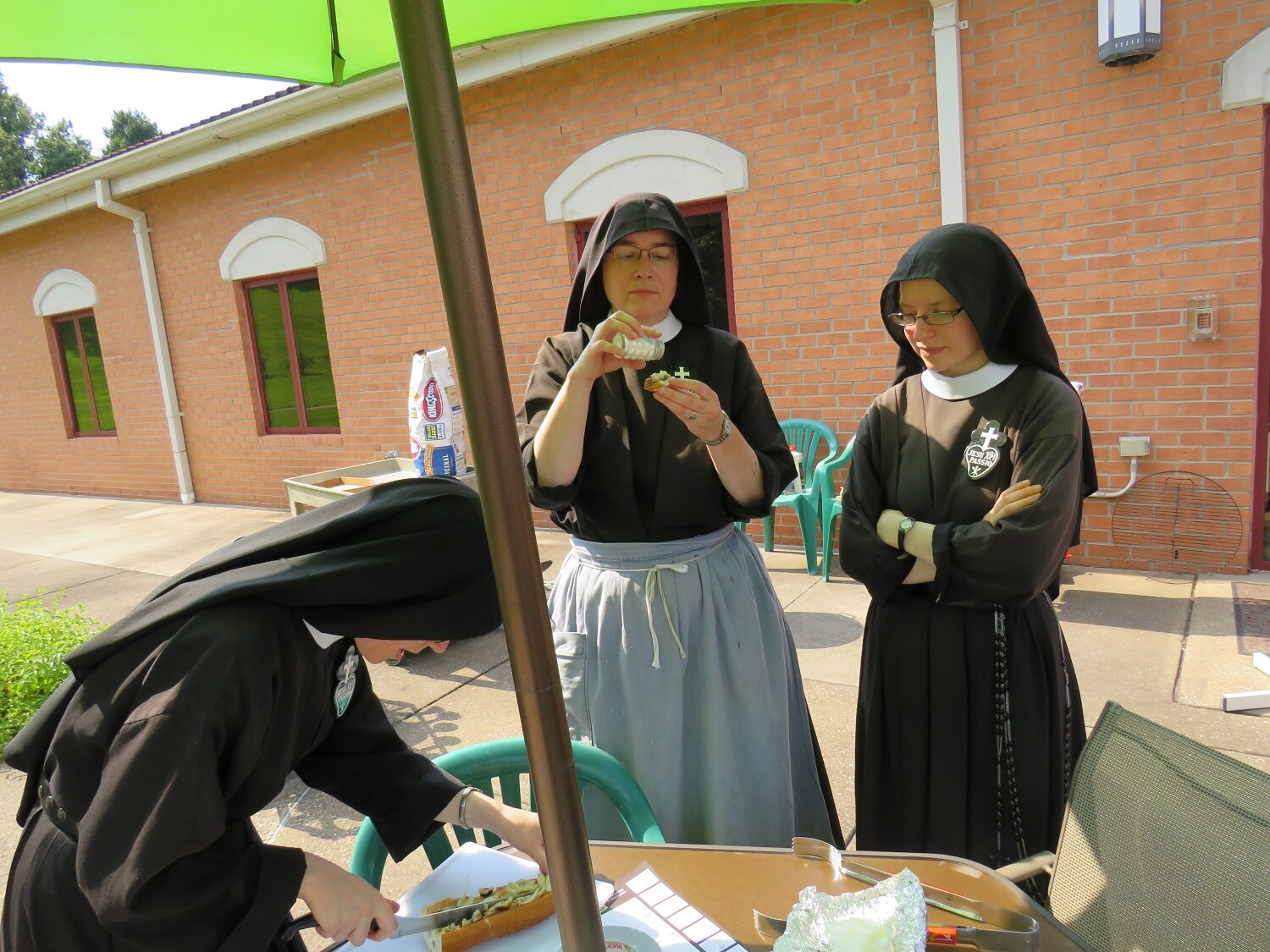 Sister Maria Faustina slices up the snacks for Mother John Mary and Sister Frances Marie 