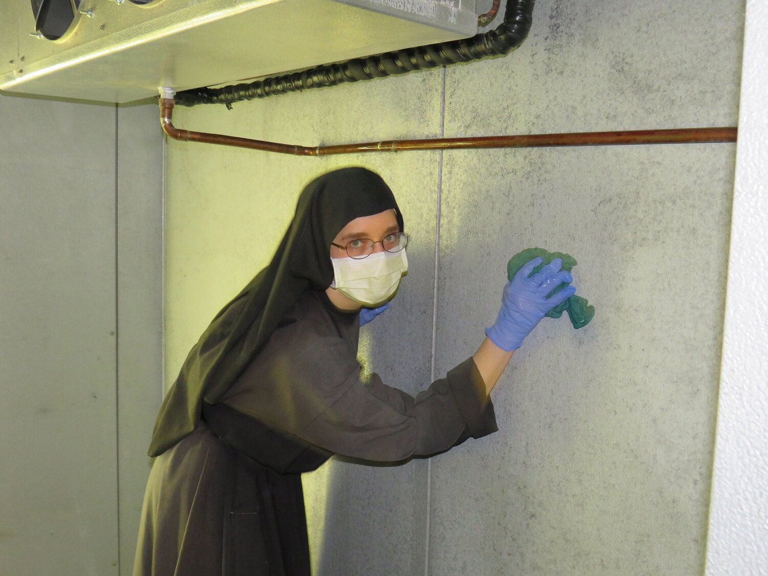  Sister Mary Andrea getting those walls squeaky-clean! 