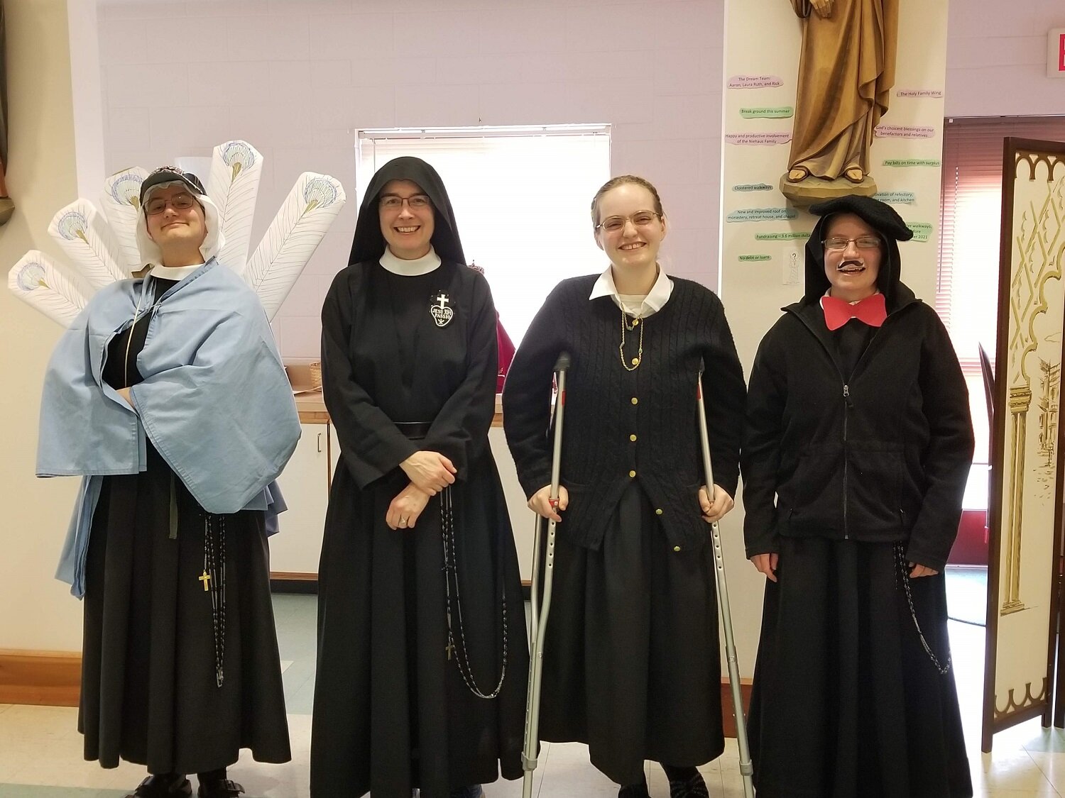  Mother John Mary poses with the cast for the skit: Sr. Miriam Esther as The Peacock, Postulant Abbey as Flannery O'Connor, and Sr. Frances Marie as Everyone Else 