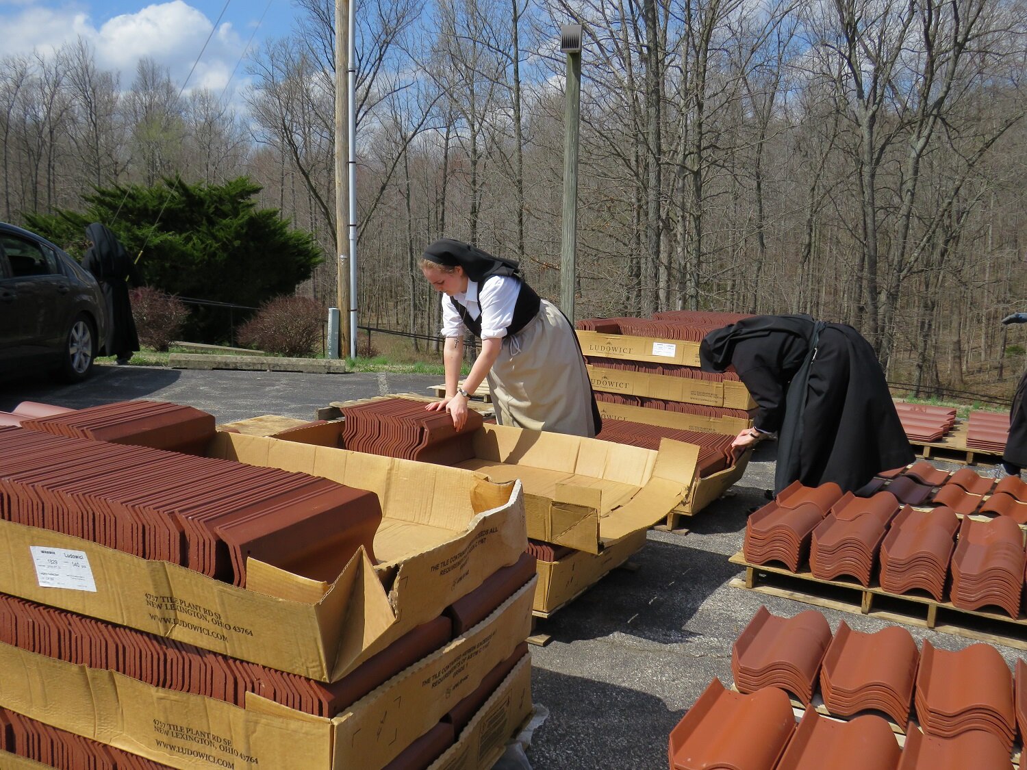  March 24 - the nuns are helping by blending the tiles onto pallets, so the roofers can stay on the roof! 