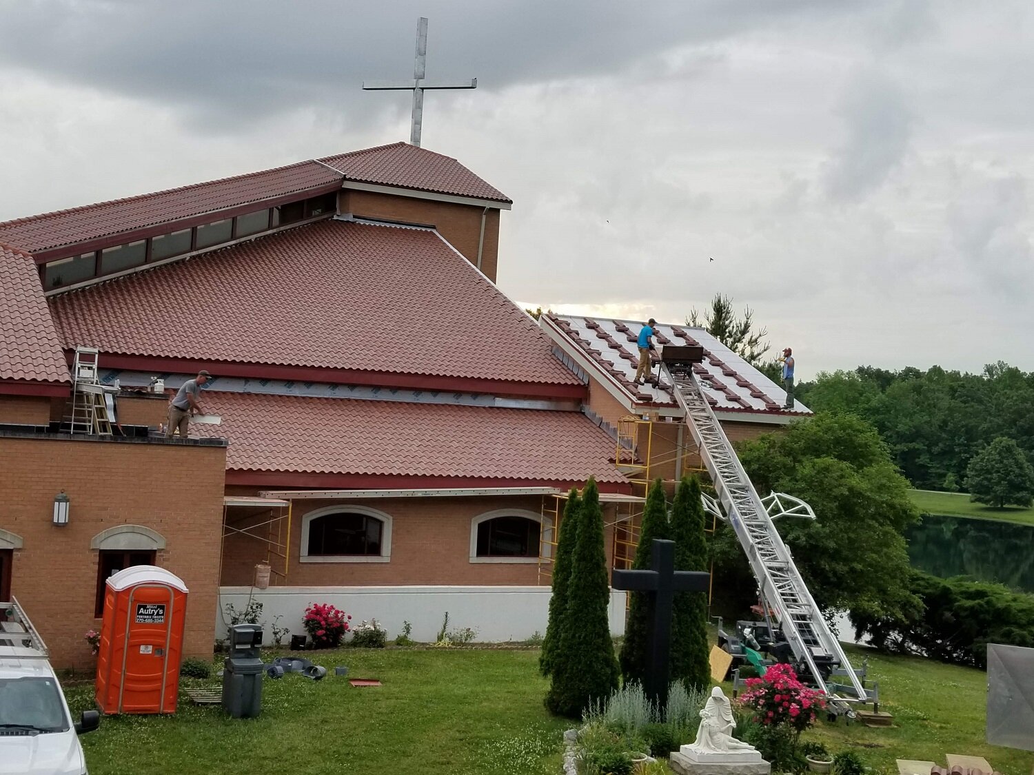  May 26 - loading tiles onto the last chapel roof section! 