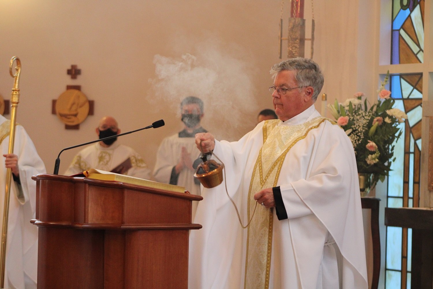  Fr. John Schork, CP, uses incense before proclaiming the Gospel from John 15 