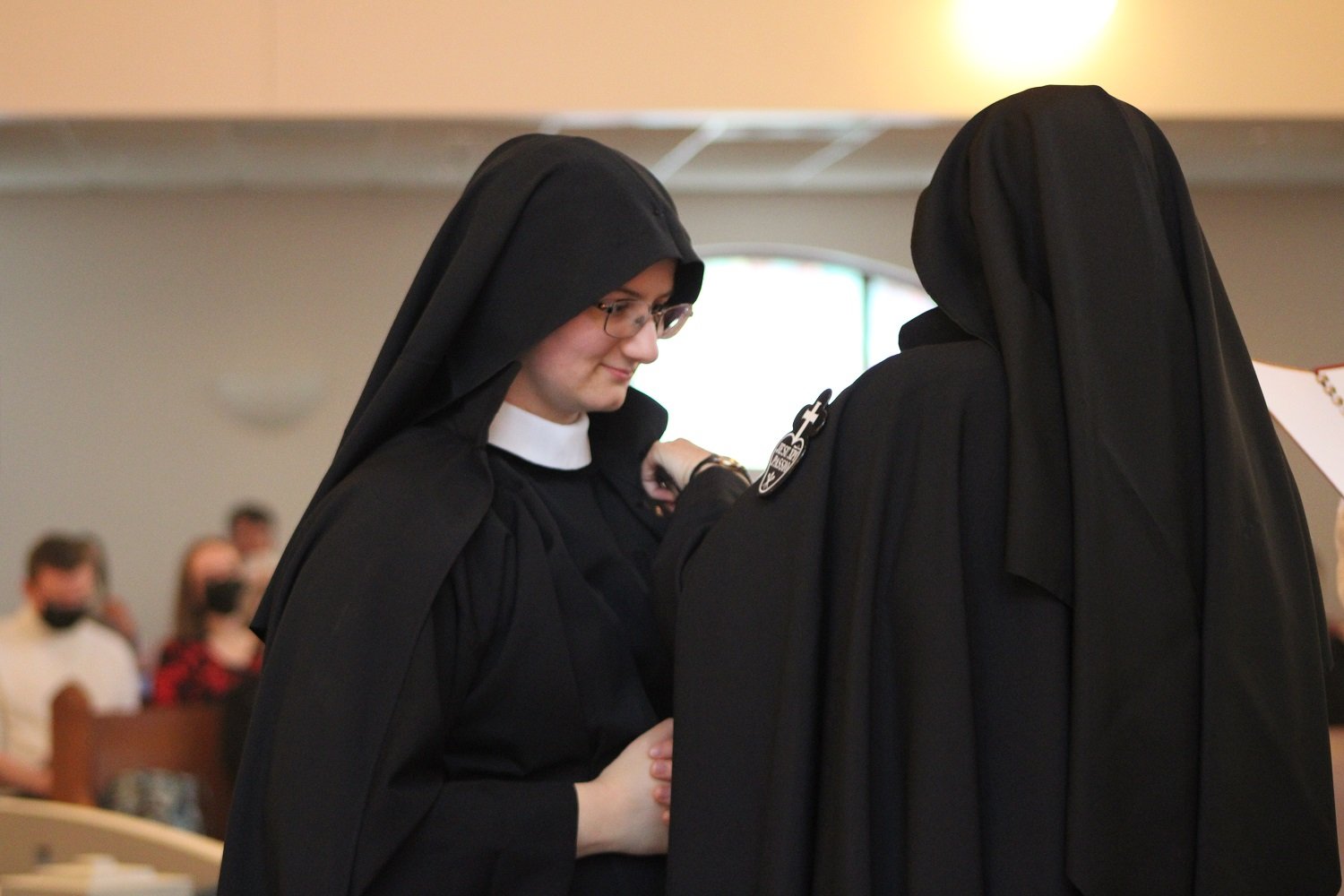  Mother John Mary places the distinctive Passion Sign on the habit and mantle of our newly-professed Sister 