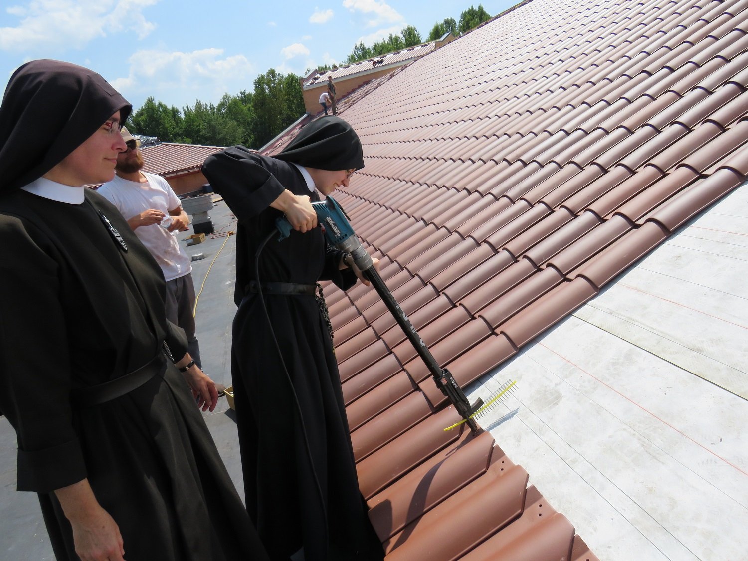  August 5 - Mother John Mary and Sr Frances Marie get in on the action on the front roof of the monastery 