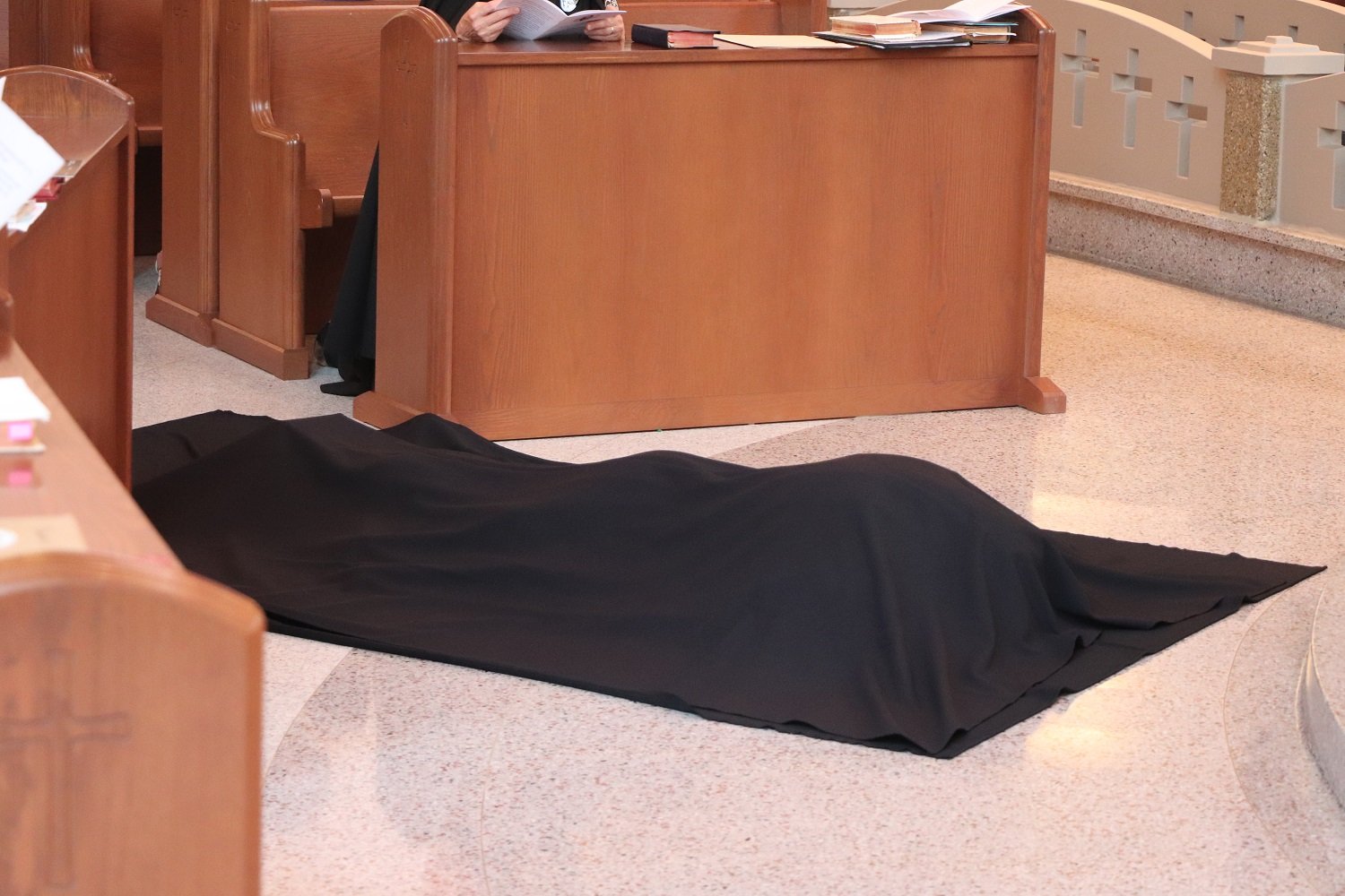  Sister lies prostrate beneath a black funeral pall as the Litany of the Saints is chanted 