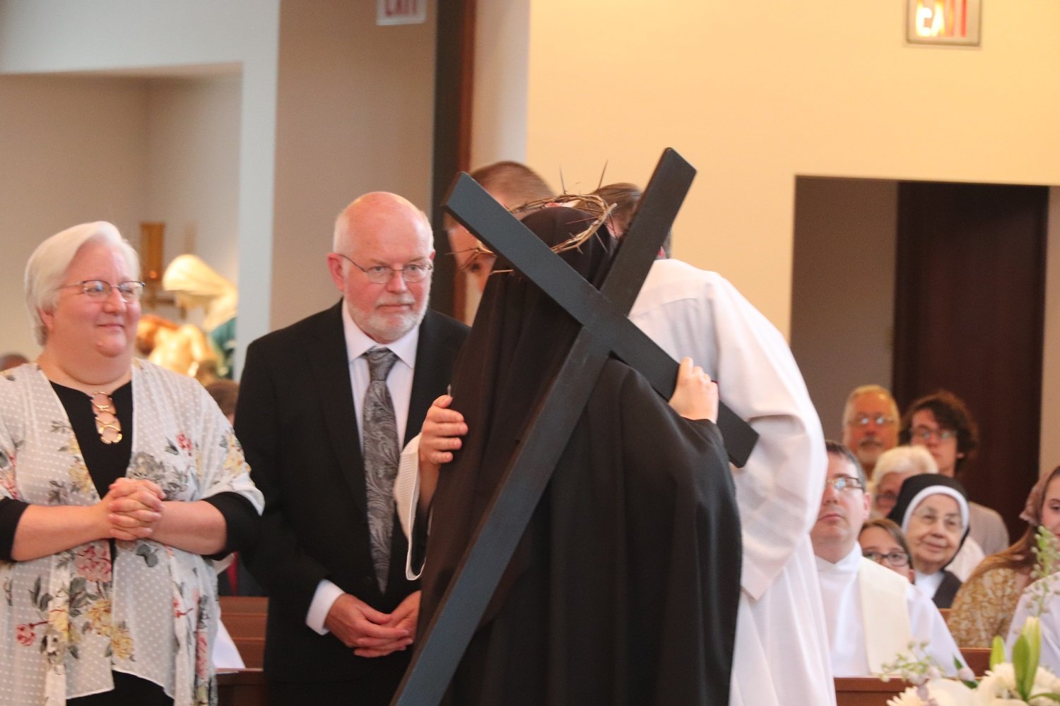  The two religious in the family — Sister Frances Marie and Br. Emmanuel — exchange the Sign of Peace as their proud parents look on 