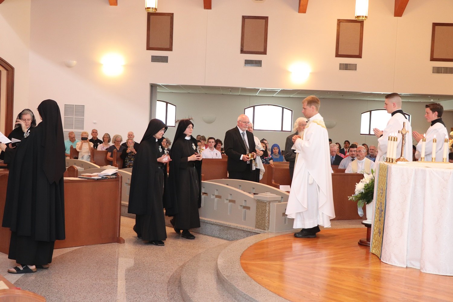  The Offertory procession: Sr. Mary Veronica (Novice Directress), Sr. Frances Marie, and her parents and grandfather bring the gifts to the altar 