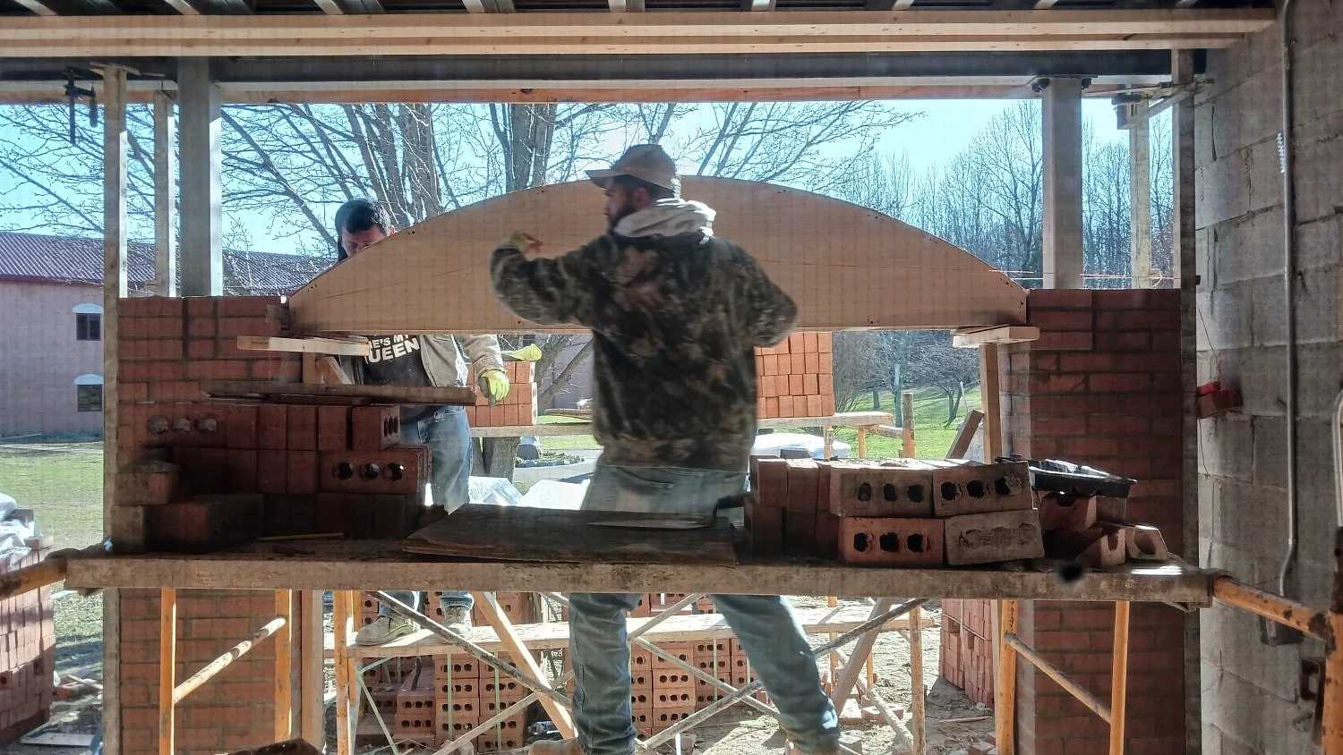Preparing the wooden form that will support the brick arch as it dries and hardens